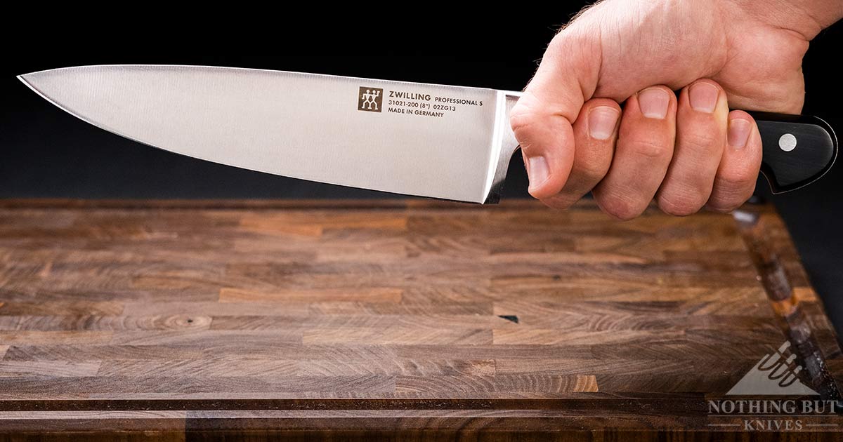 A close-up of the Zwilling Profeessional S 8 inch chef knife in a hammer grip.
