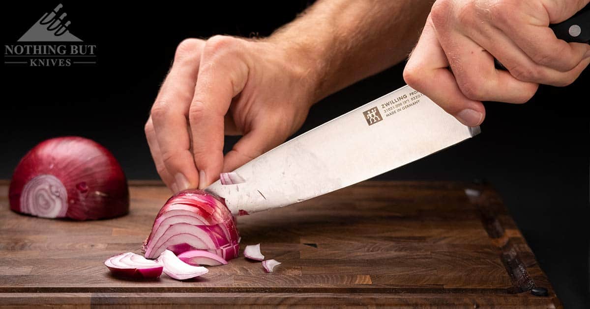 A close-up of the Professional S blade cutting through an onion. 