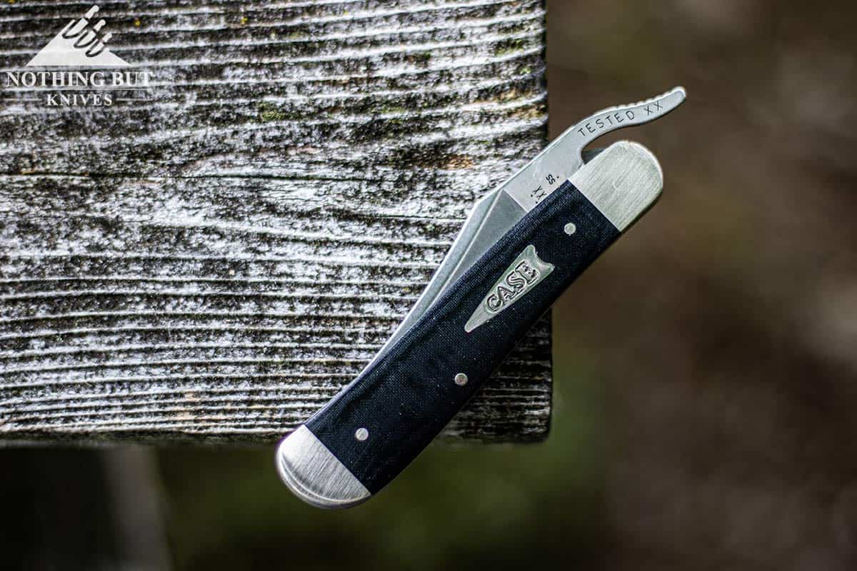 Case Russlock Review - Image 1 Case RussLock pocket knife on the corner of a weathered wood picnic table.