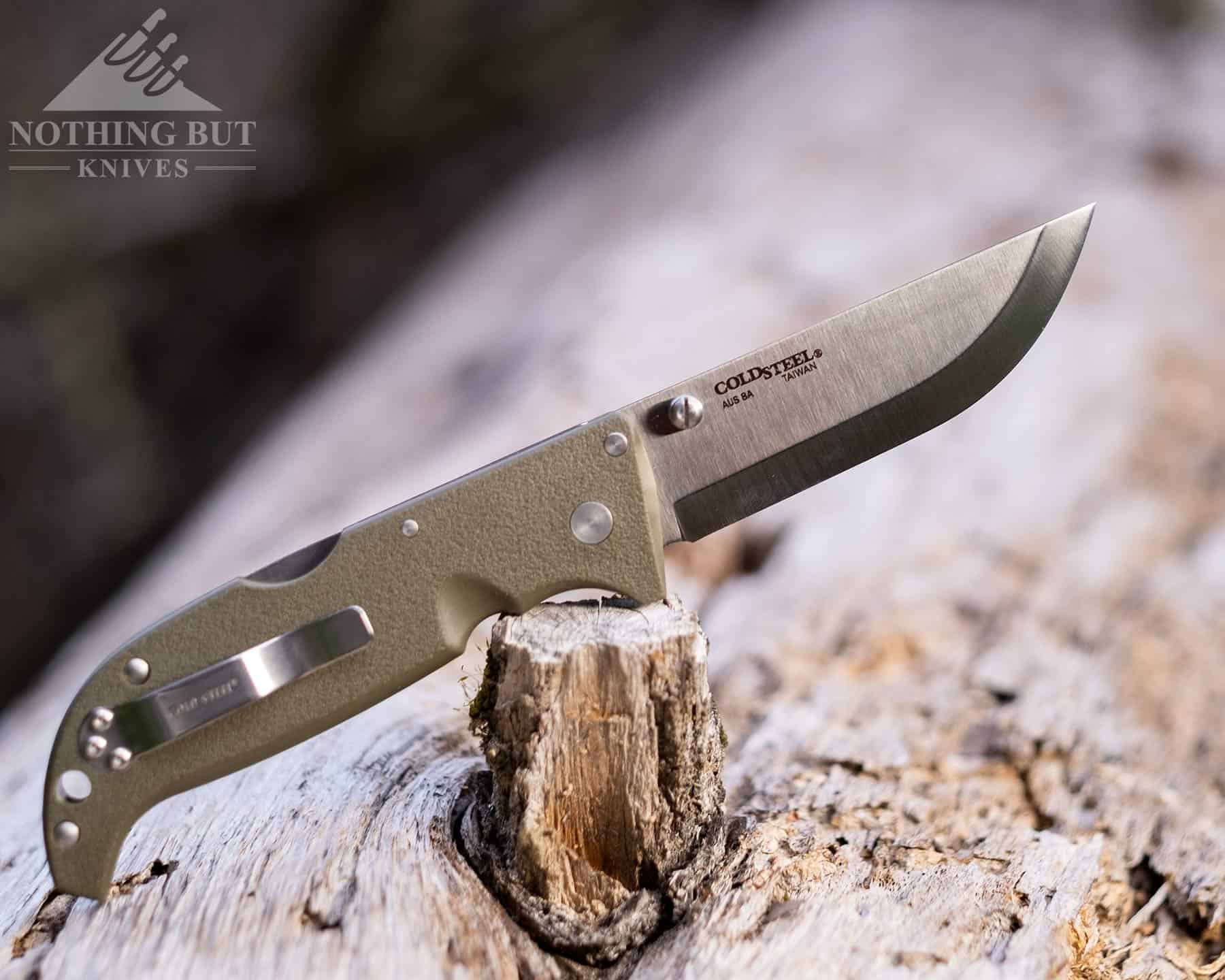 The Cold Steel Finn Wolf is a cheaper alternative to the AD 20.5. It is shown here outdoors on a log in the open position. 