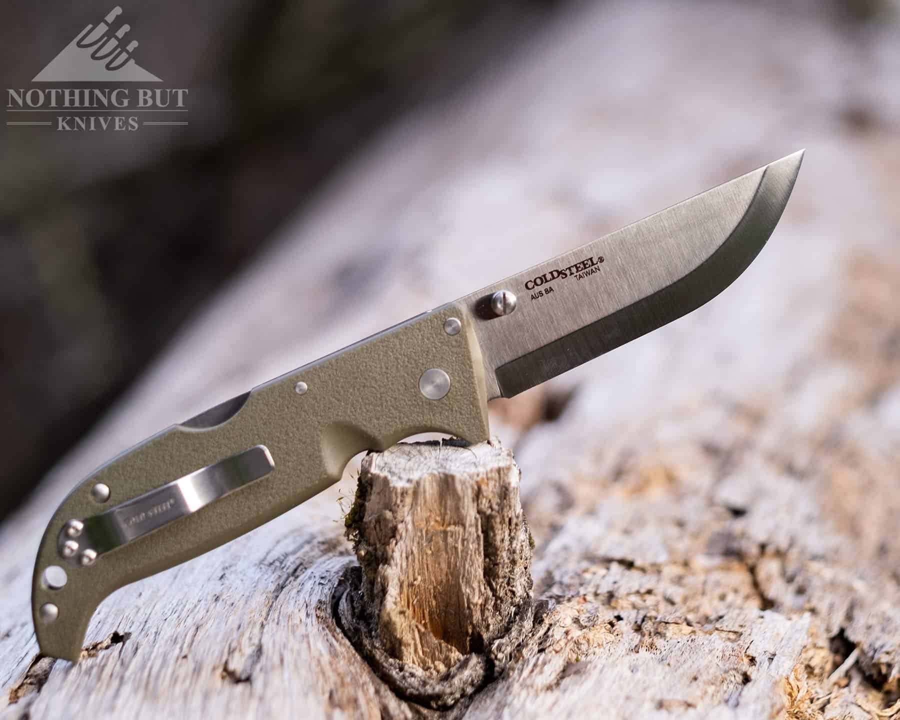 Demko Ad 20.5 Review - Image 15 The Cold Steel Finn Wolf is a cheaper alternative to the AD 20.5. It is shown here outdoors on a log in the open position.
