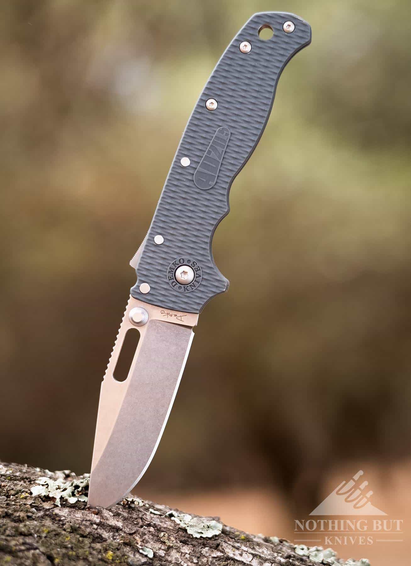 Demko Ad 20.5 Review - Image 13 The AD 20.5 folding knife sticking out of the bark of an Oak tree.