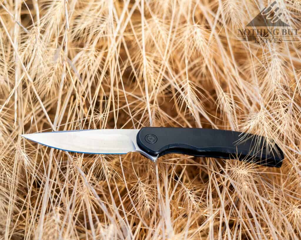 The Civivi Nox is a compact folder with quality steel. Shown here in a field of grass. 