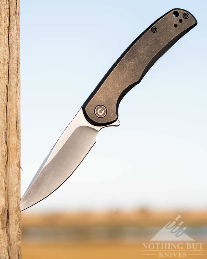 The Civivi NOx is a compact sized all-around capable EDC knife. Shown hear sticking in a fence post. 