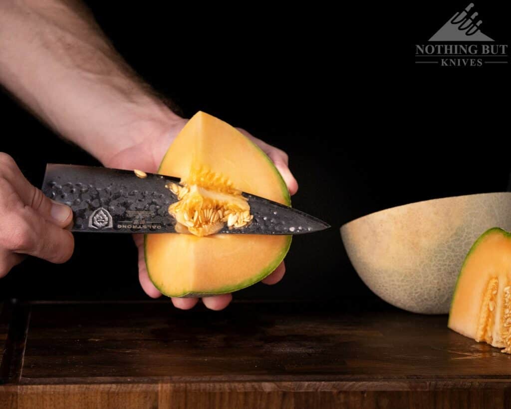Dalstrong Shogun Series X Chef Knife Review - Image 14 A close-up of the Dalstrong Shogun X chef knife cutting the core from a melon.