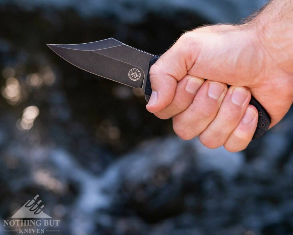 The Off-Grid Caiman in a full hammer grip in a man's hand. 