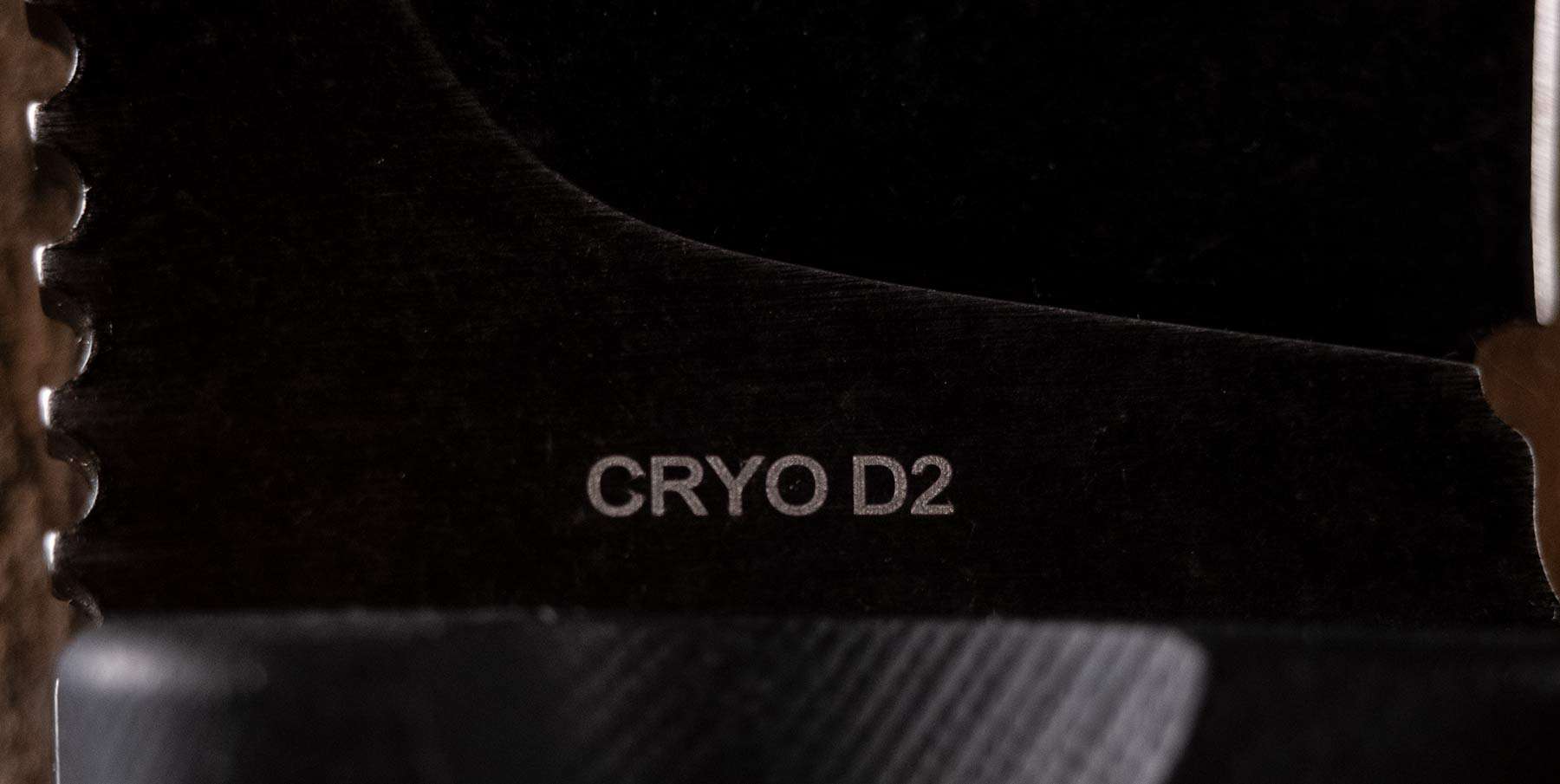 A close-up of the Cryo D2 steel logo on a fixed blade knife made by Off-Grid Knives.