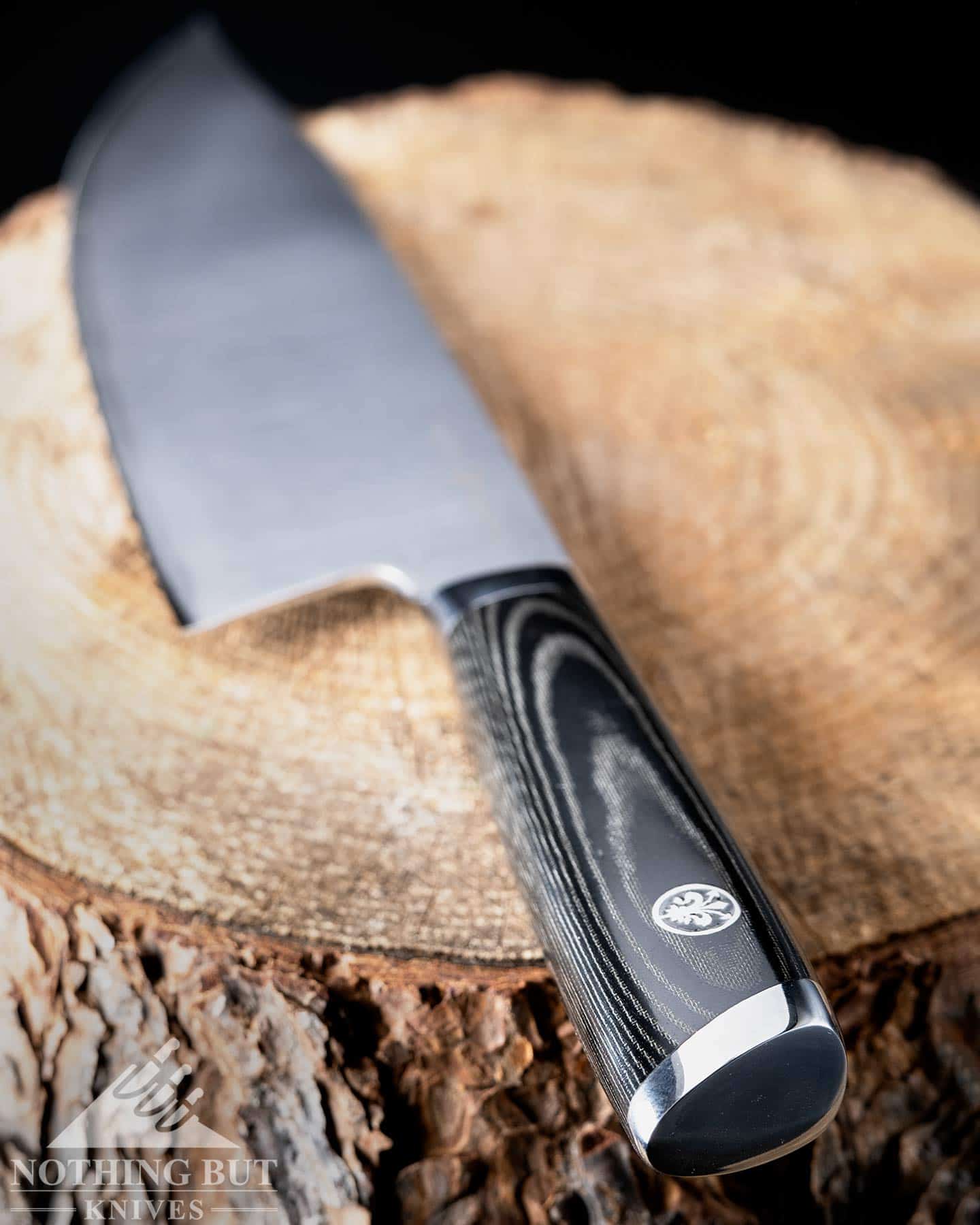 A shallow depth of field image showing a close-up of the Mattia Borrani Bowie chef knife handle. 