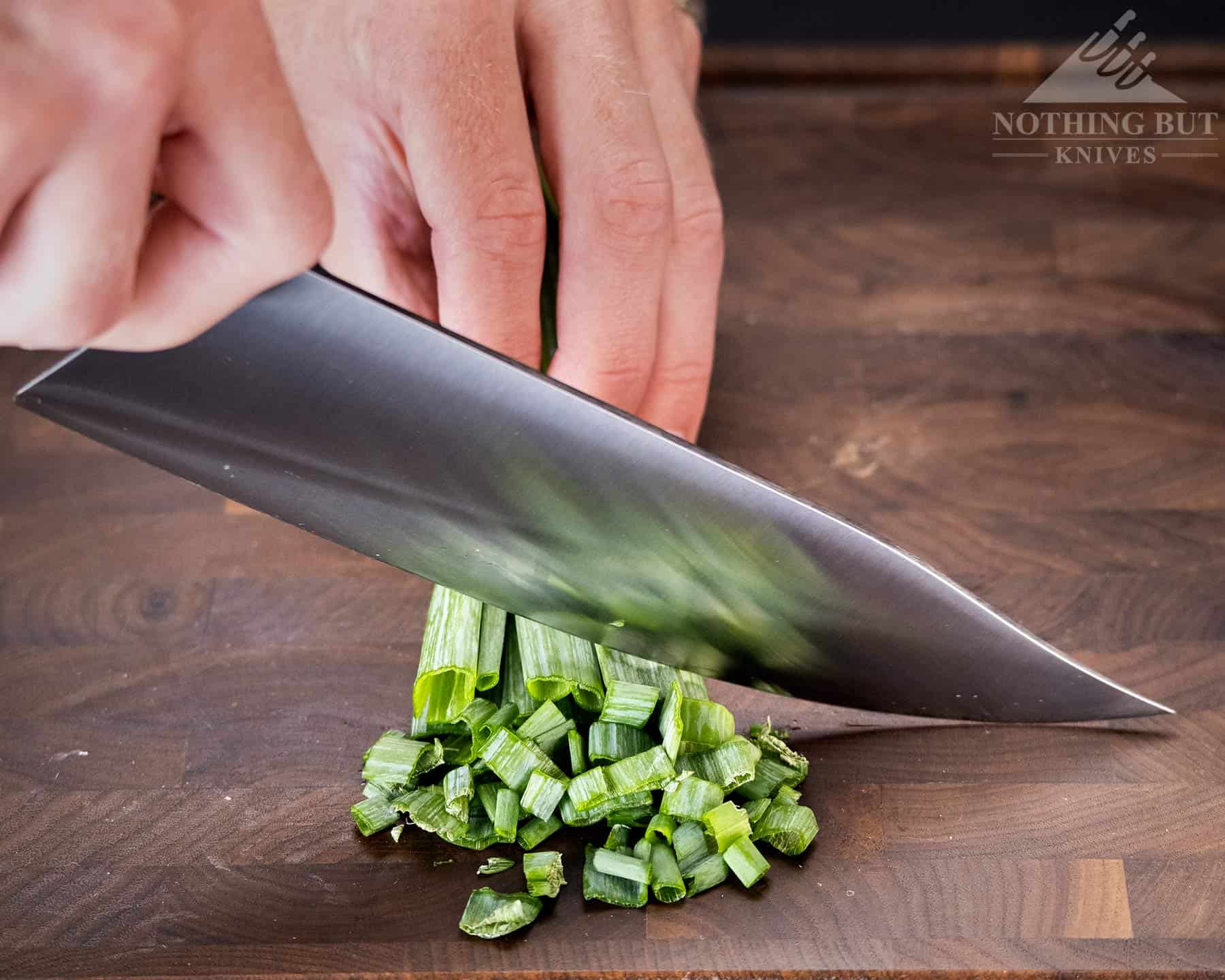 Mattia Borrani Bowie Chef Knife Review - Image 4 The Mattia Borrani Bowie chef knife is not the best choices for cutting super fine pieces. It is shown here chopping green onions.
