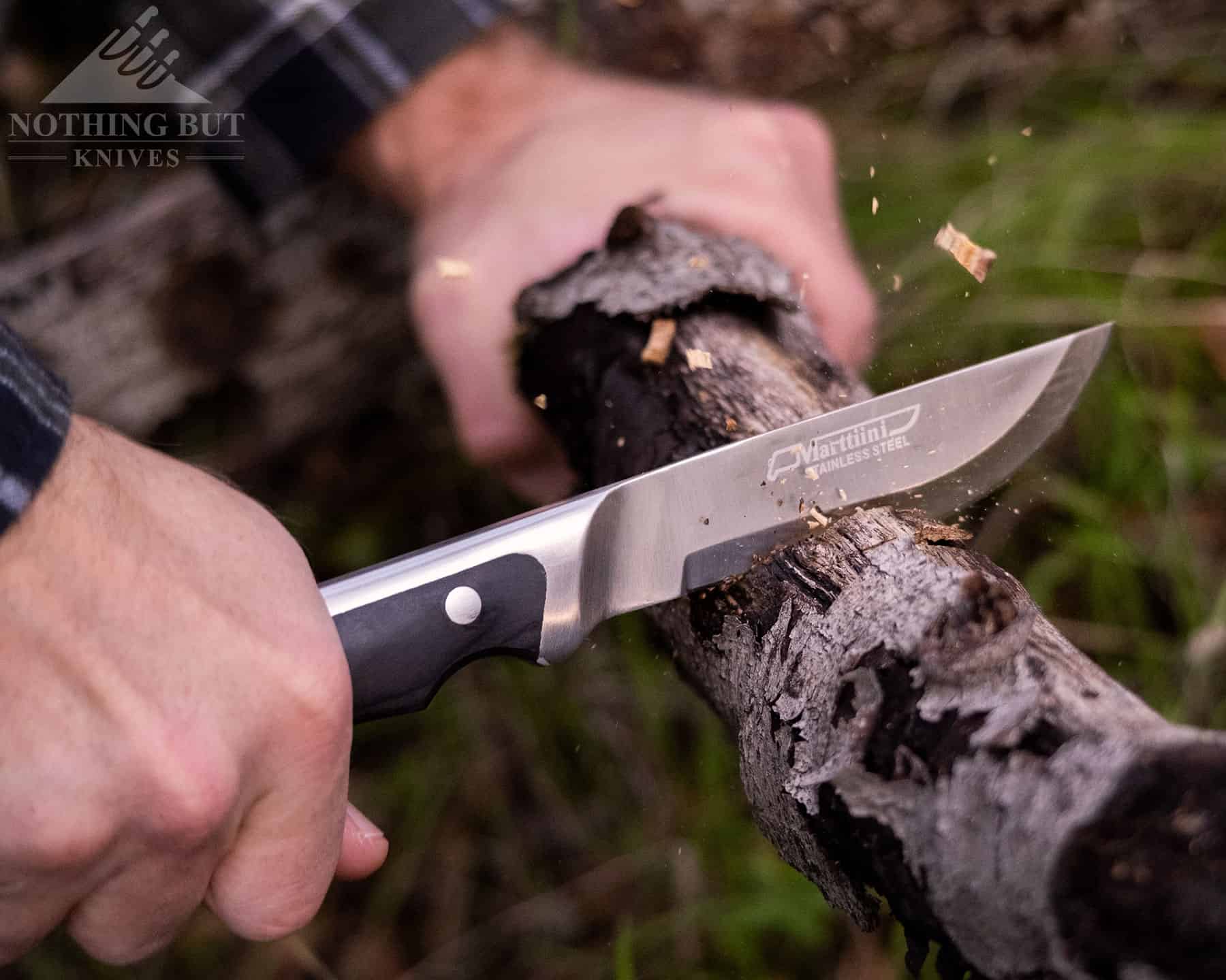 The long contoured handle, great balance and scandi grind of the blade make the Marttiini Full Tang a great chopper. It is shown here chopping through a small log. 