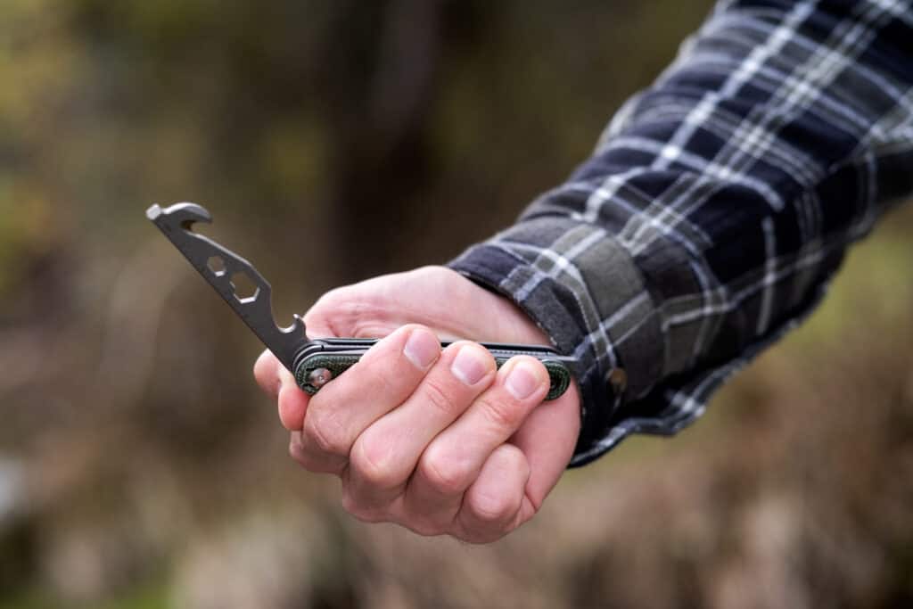 A person opening the tool bar on the Civivi Crit using the front flipper tab. 