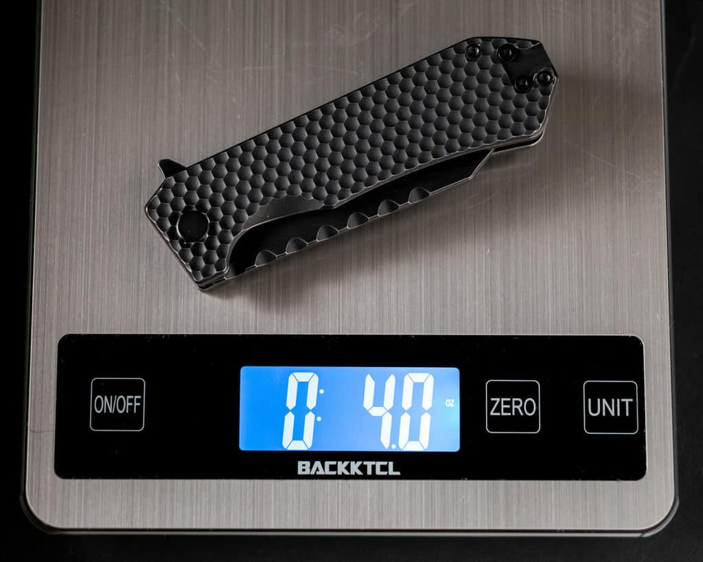 The OffGrid Black Mamba V2 pocket knife on a digital scale to show that it is lighter than the original.