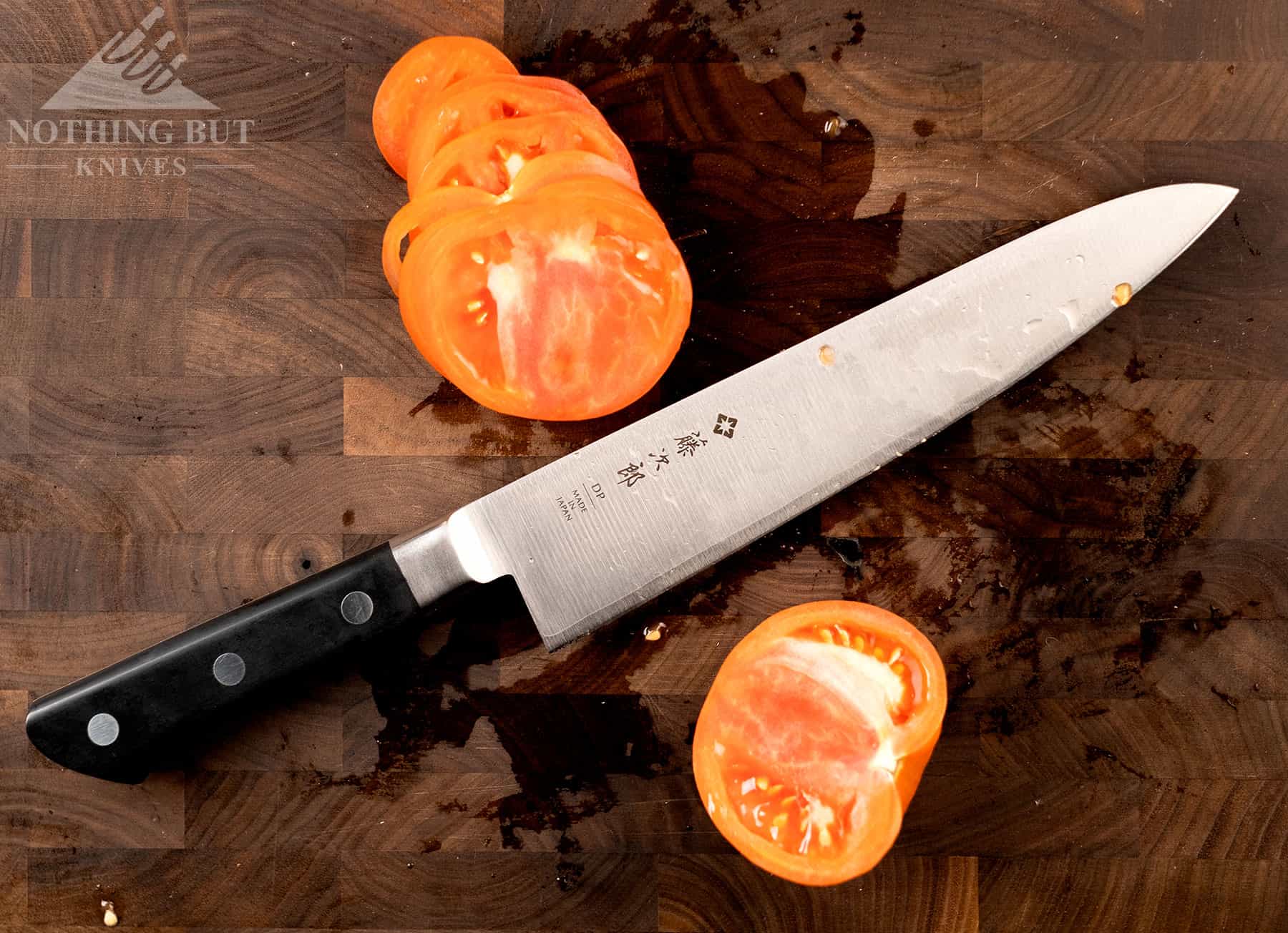 This overhead image of the Tojiro DP chef knife shows the blade curvature and sloped bolster. 