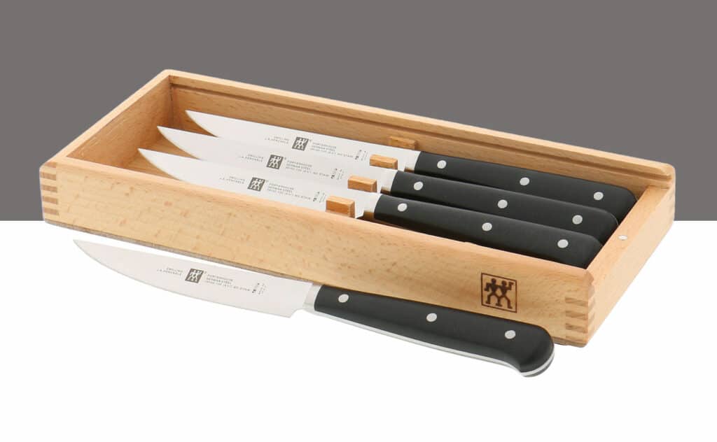 Set of four Zwilling Porterhouse steak knives in a wood gift box.