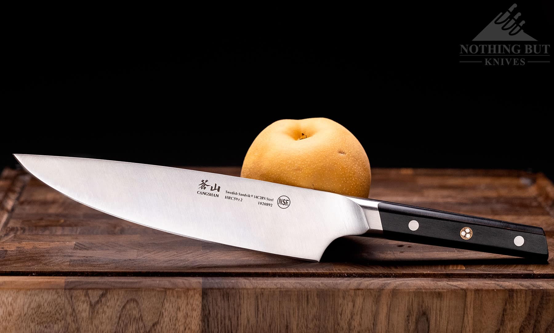 The profile side of the Cangshan TC chef knife shown sext to an Asian pear to show scale.