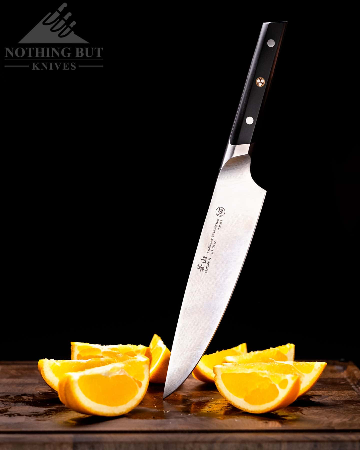 Header image for are in-depth review of the 8 inch Cangshan TC chef knife. It is shown her surrounded by orange slice it has just cut.