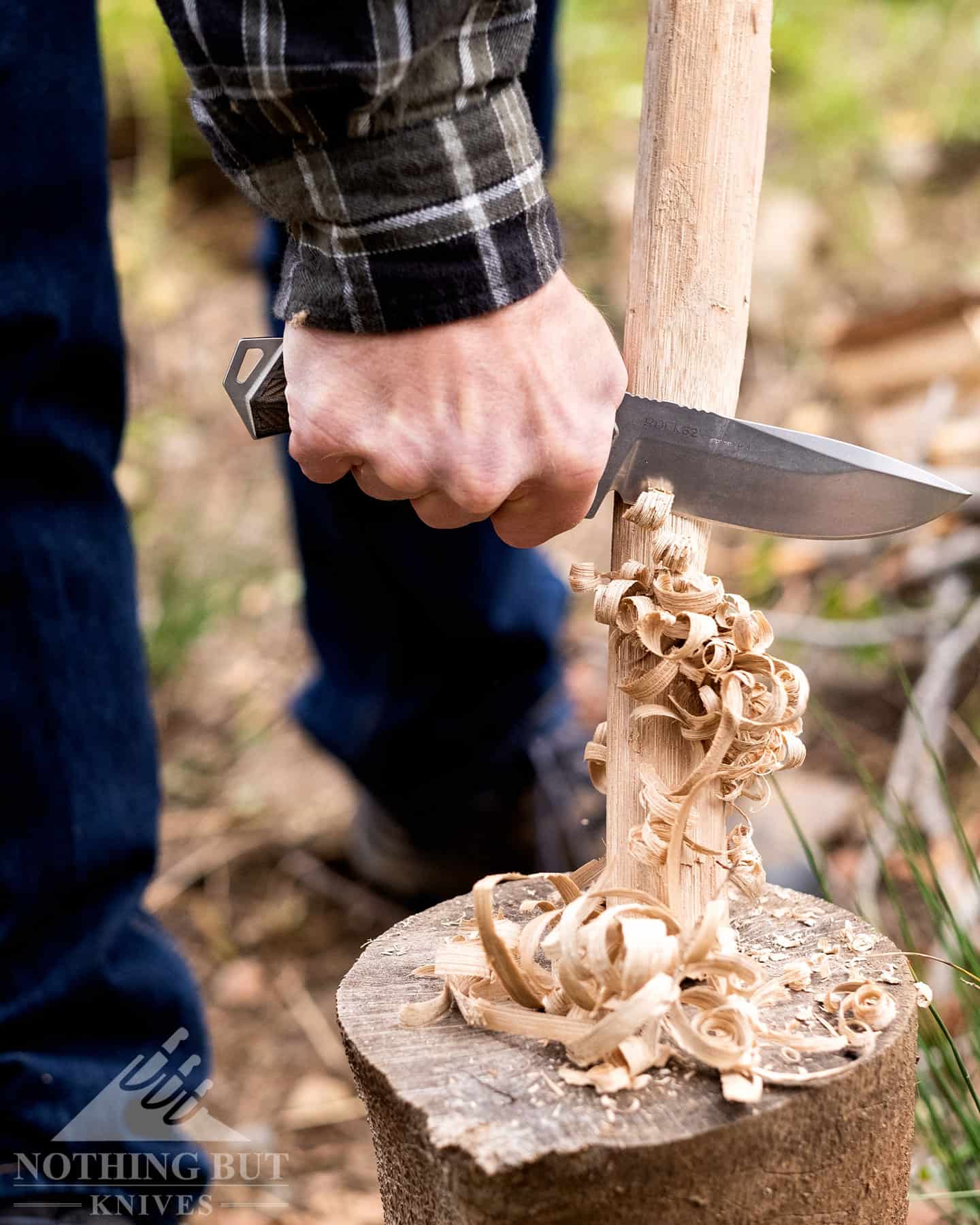 The Woox 62 is shown here creating a feather stick to start a campfire.