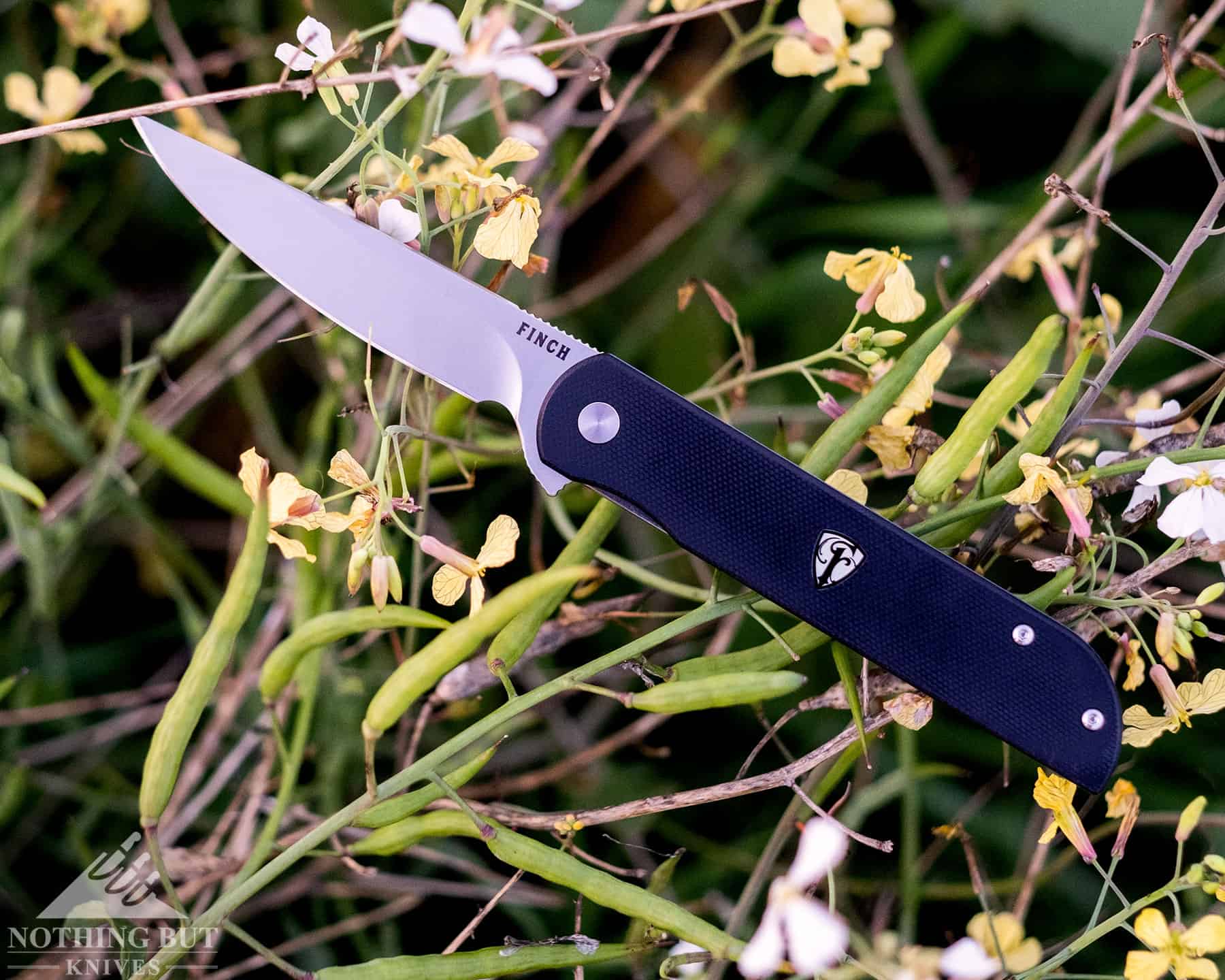 Finch Knife Co Cimarron Review - Image 7 Finch folding knife laying in the grass of a field.