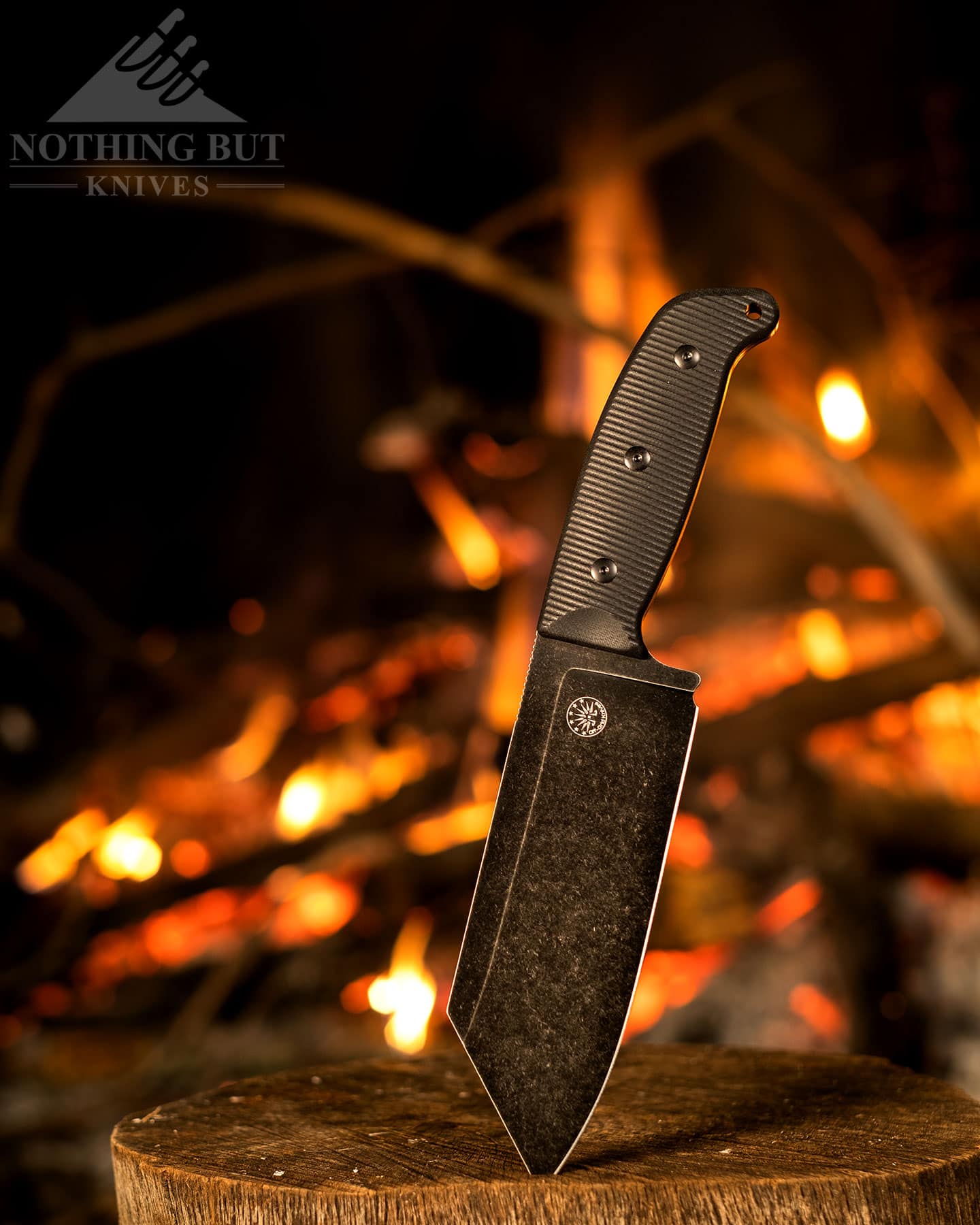 The Off-Grid Grizzly is a great all around camping chef knife. It is shown here next to a campfire. 