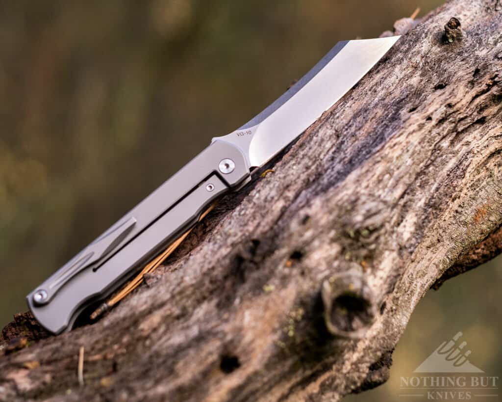 The Katsu JT01 Camping knife on a tree branch in the woods.