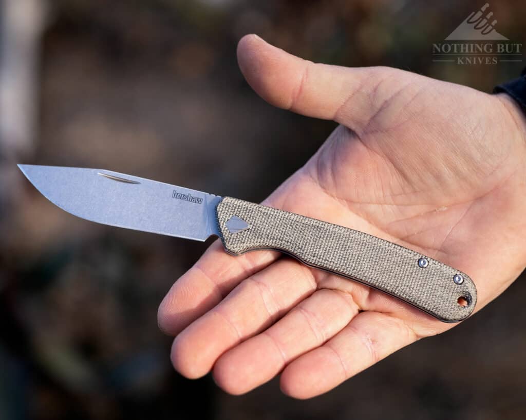 The Kershaw Federalist slipjoint in the open position in the palm of a person's hand to show scale. 