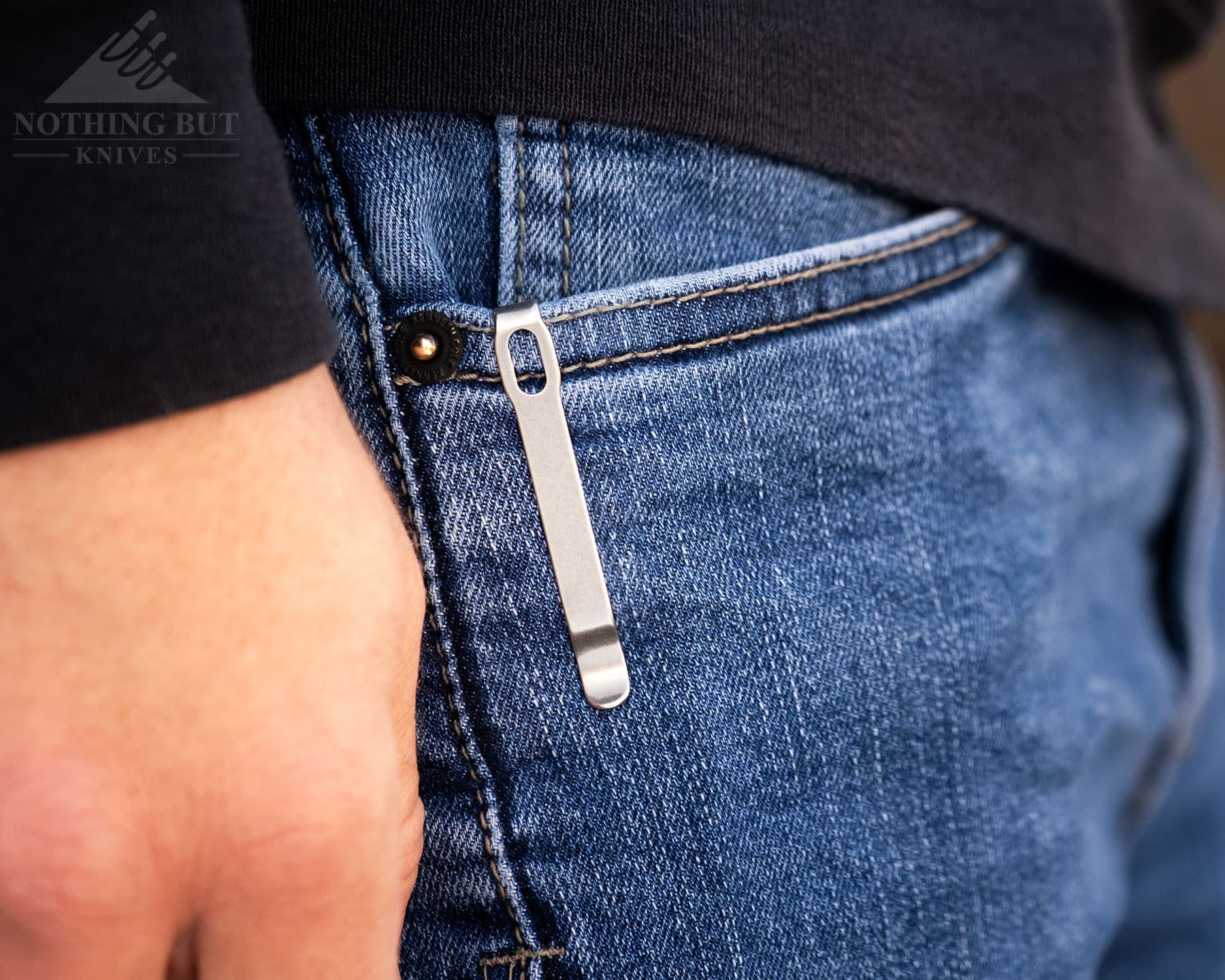 Best Slip Joint Knives For Nostalgic Edc - Image 9 The CJRB Pyrite slipped in to the right front pocket of a person's jeans with its ambidextrous pocket clip.