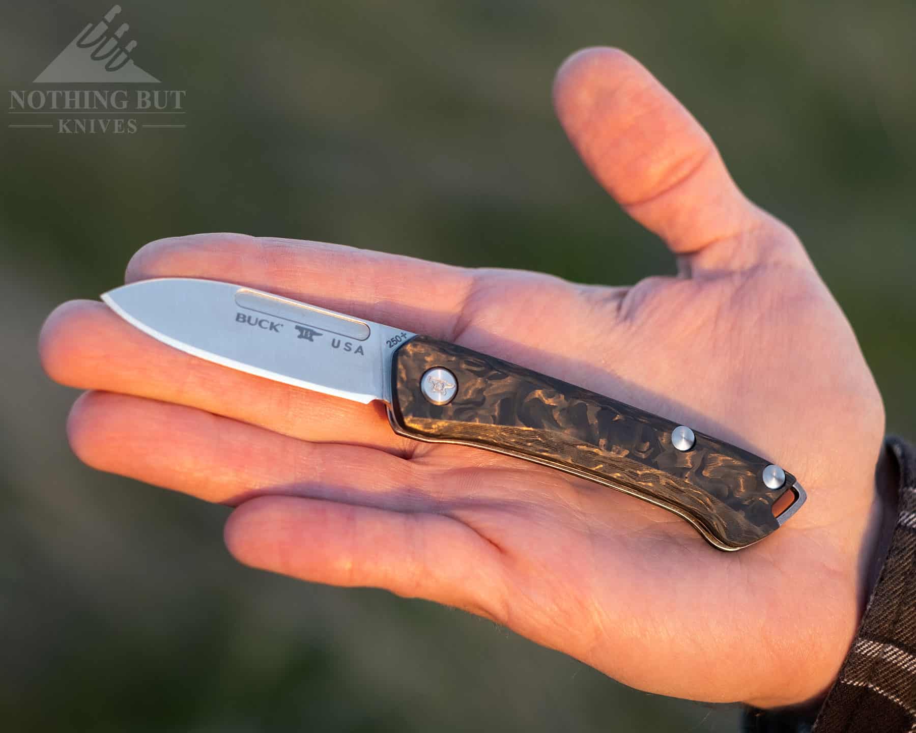 The Buck Saunter Slip Joint EDC is shown here in a person's hand to give an idea of size. 