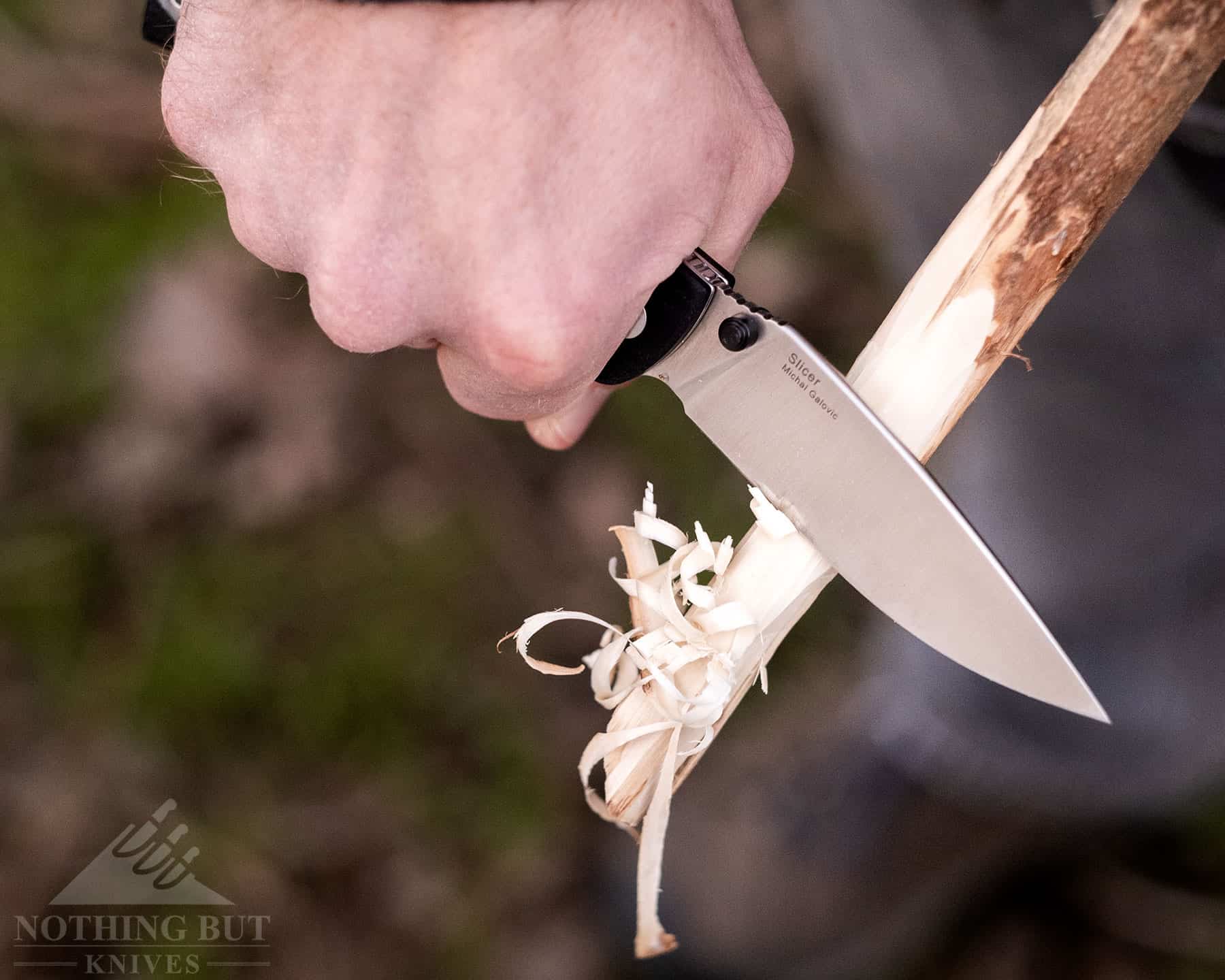 Carving a feather stick with the Kizer Slicer Lockback. 