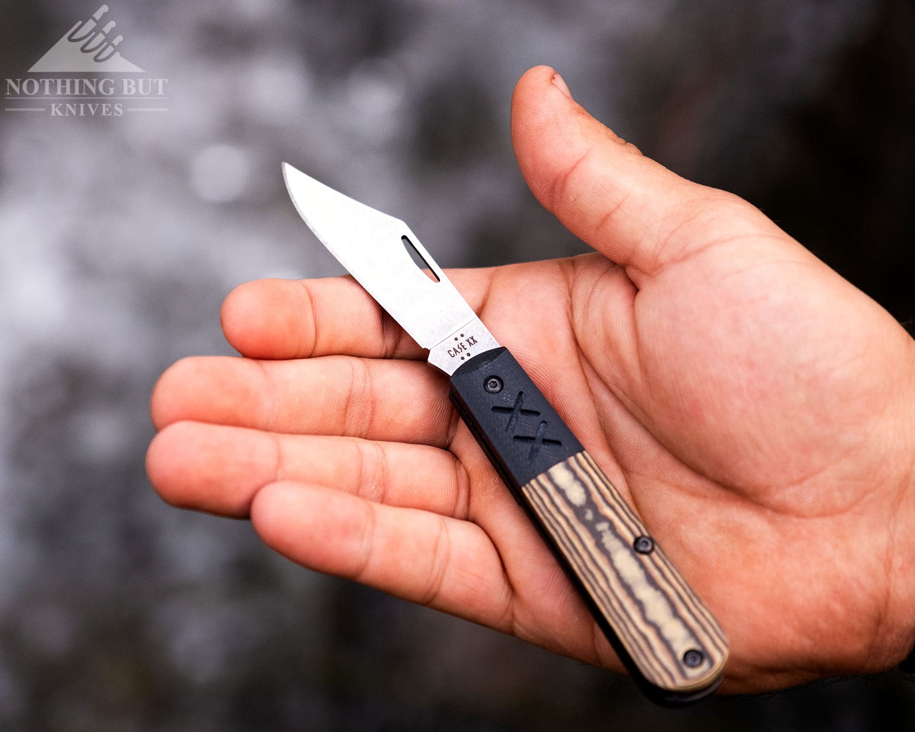 Best Slip Joint Knives For Nostalgic Edc - Image 42 An overhead view of the Case Barlow Crossroads with the blade in the open position in a person's open hand to show scale.