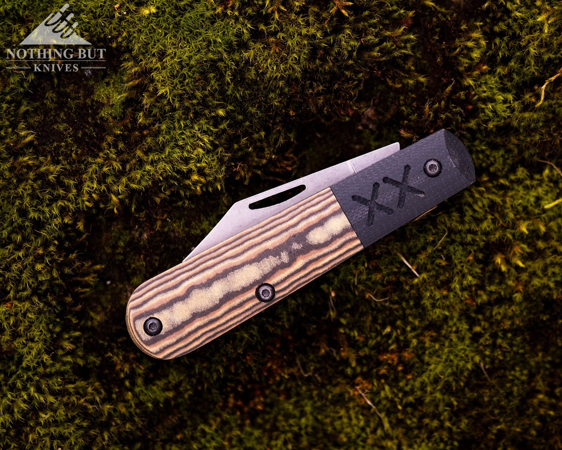 Best Slip Joint Knives For Nostalgic Edc - Image 41 An overhead view of the Case Knives Barlow Crossroads in the closed position on a moss-covered rock.