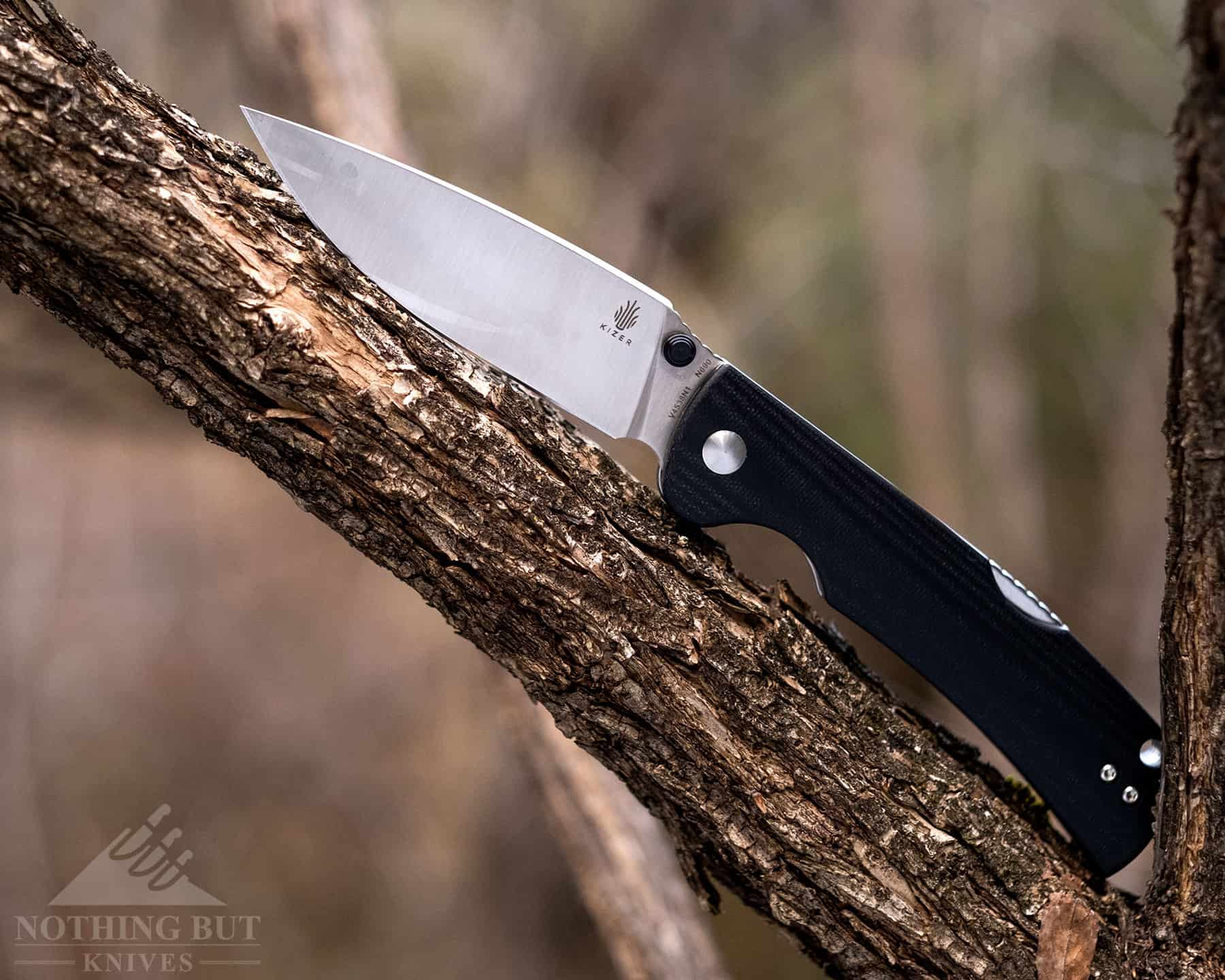 A close-up of the Kizer Slicer that shows the smudges on the satin finished blade