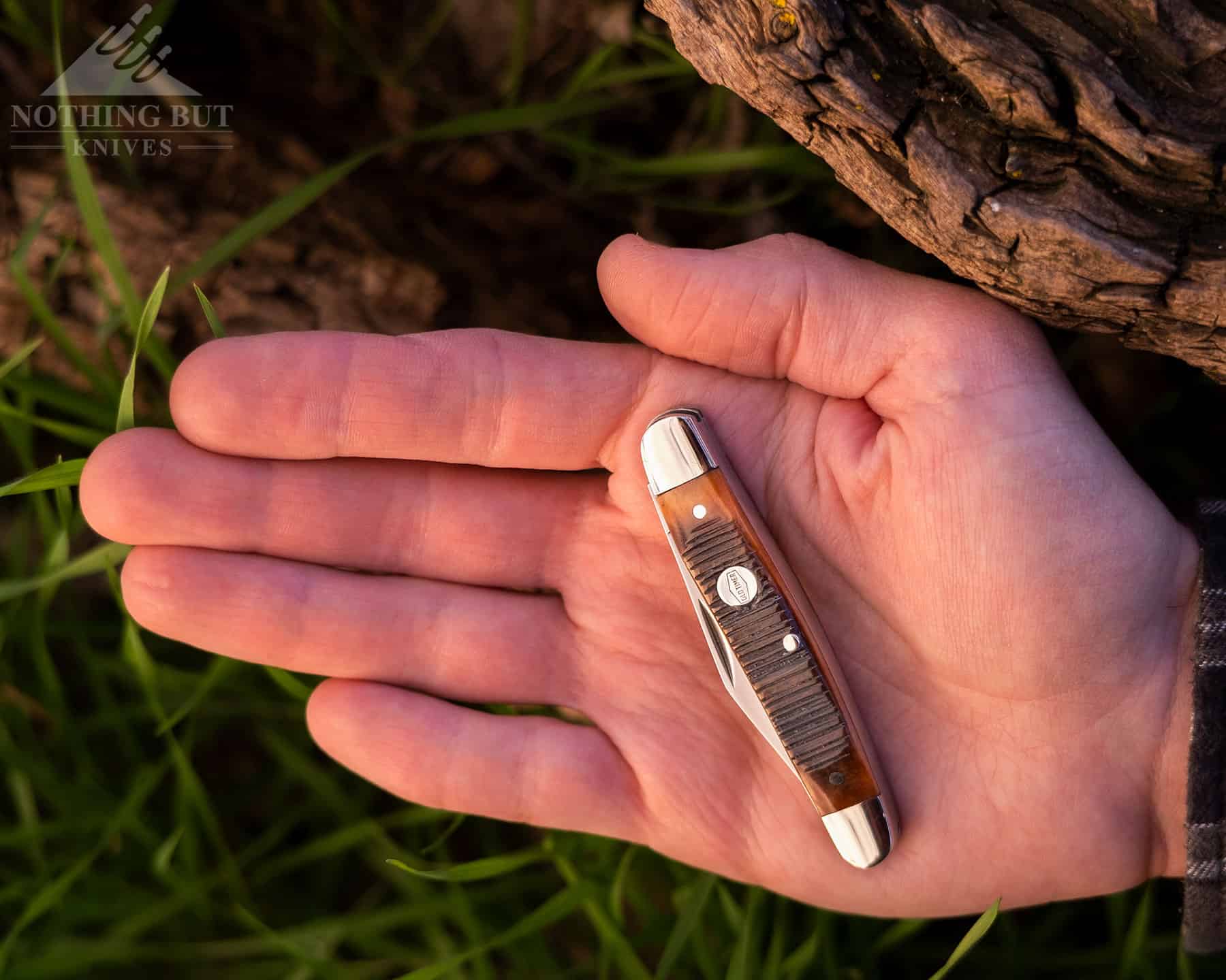 The Middleman Generational 340T in the closed position in the palm of a person's hand to show how small it is. 