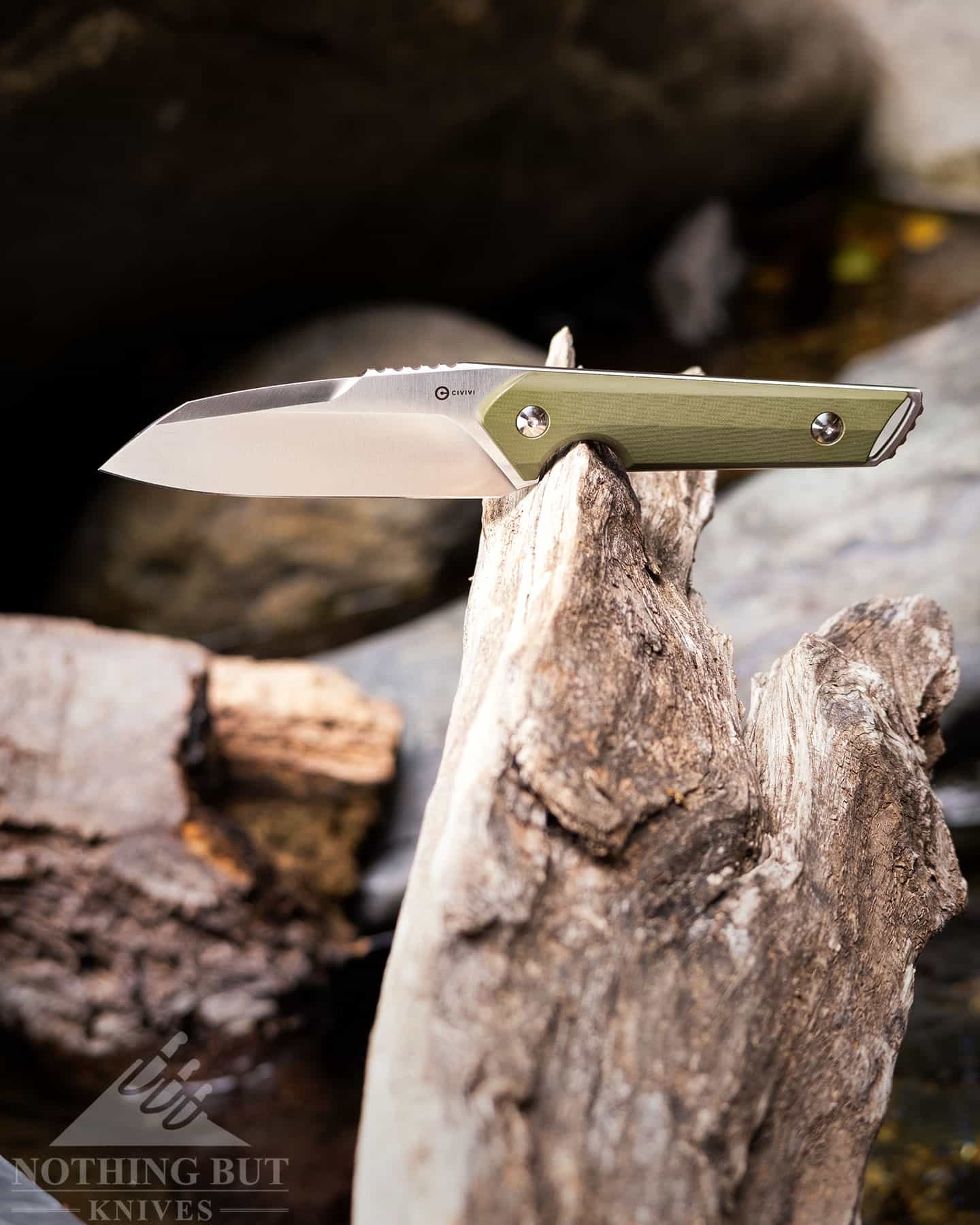 Our Search For The Best Camping Chef Knife - Image 23 The Civivi Kepler outdoors on a piece of driftwood.