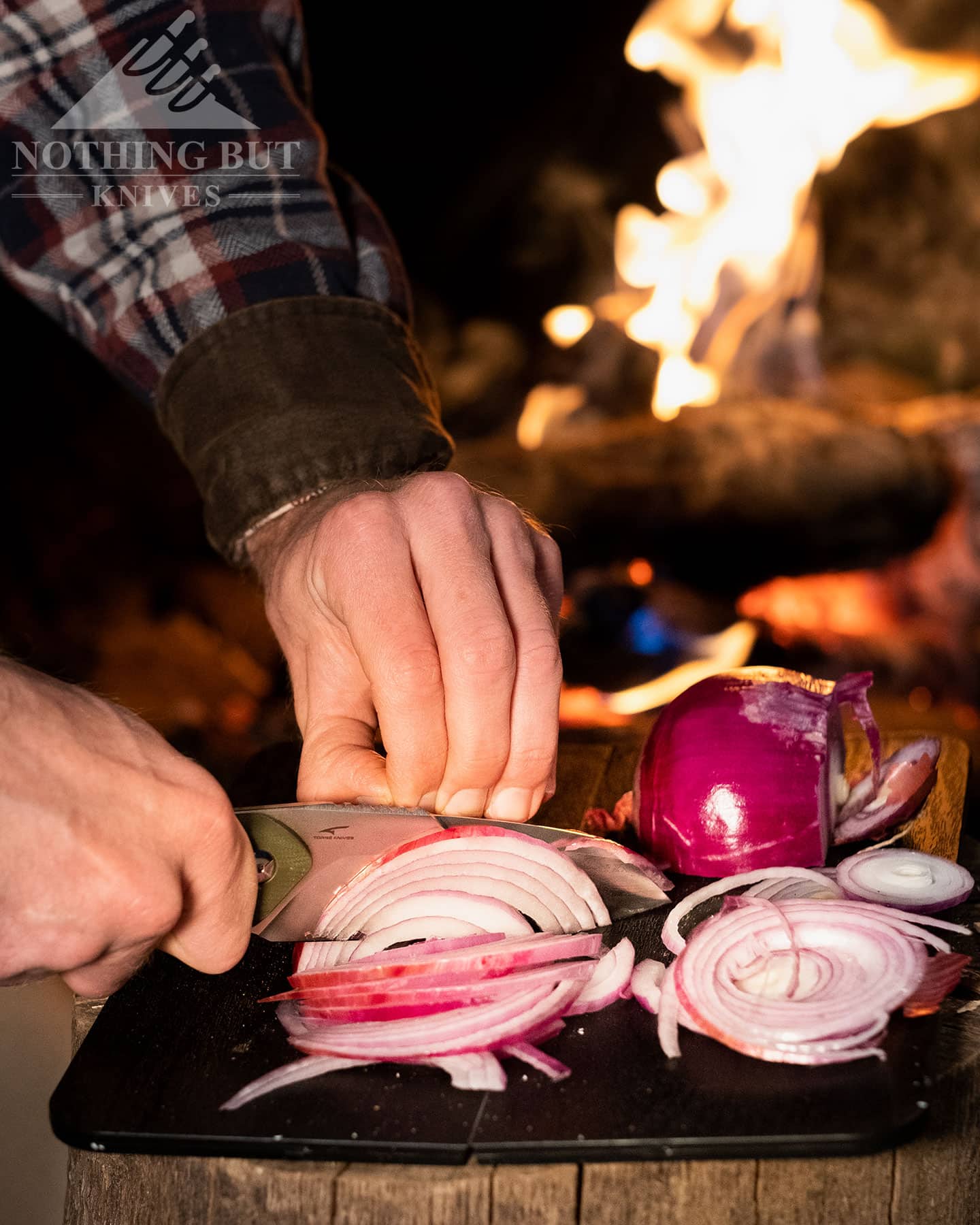 The Civivi Kepler slicing onions to show it's food preparation capabilities. 