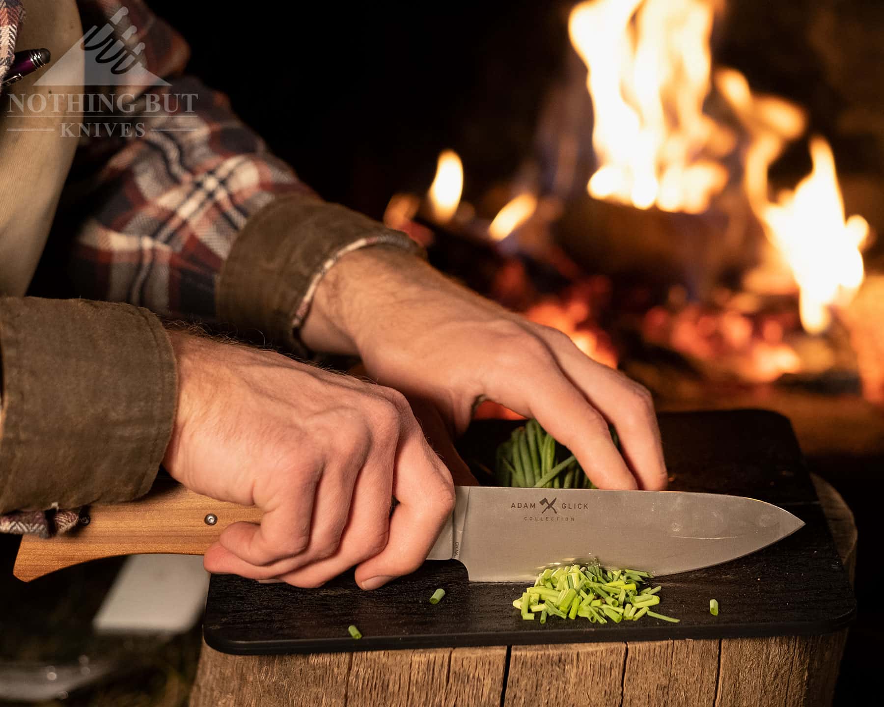 Our Search For The Best Camping Chef Knife 17 The Messermeister Adventure chef knife chopping green onions on the folding cutting board that is part of the kit.