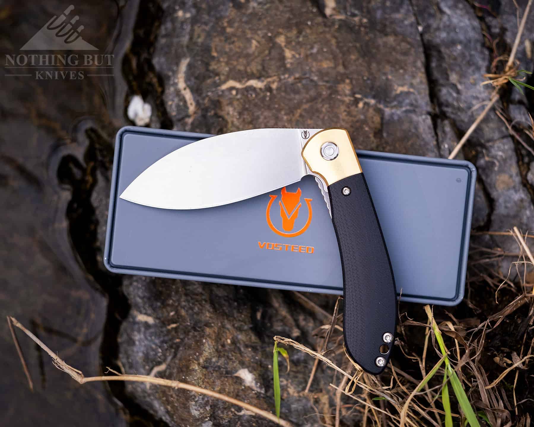 Vosteed folding knife on it's shipping case with the logo.