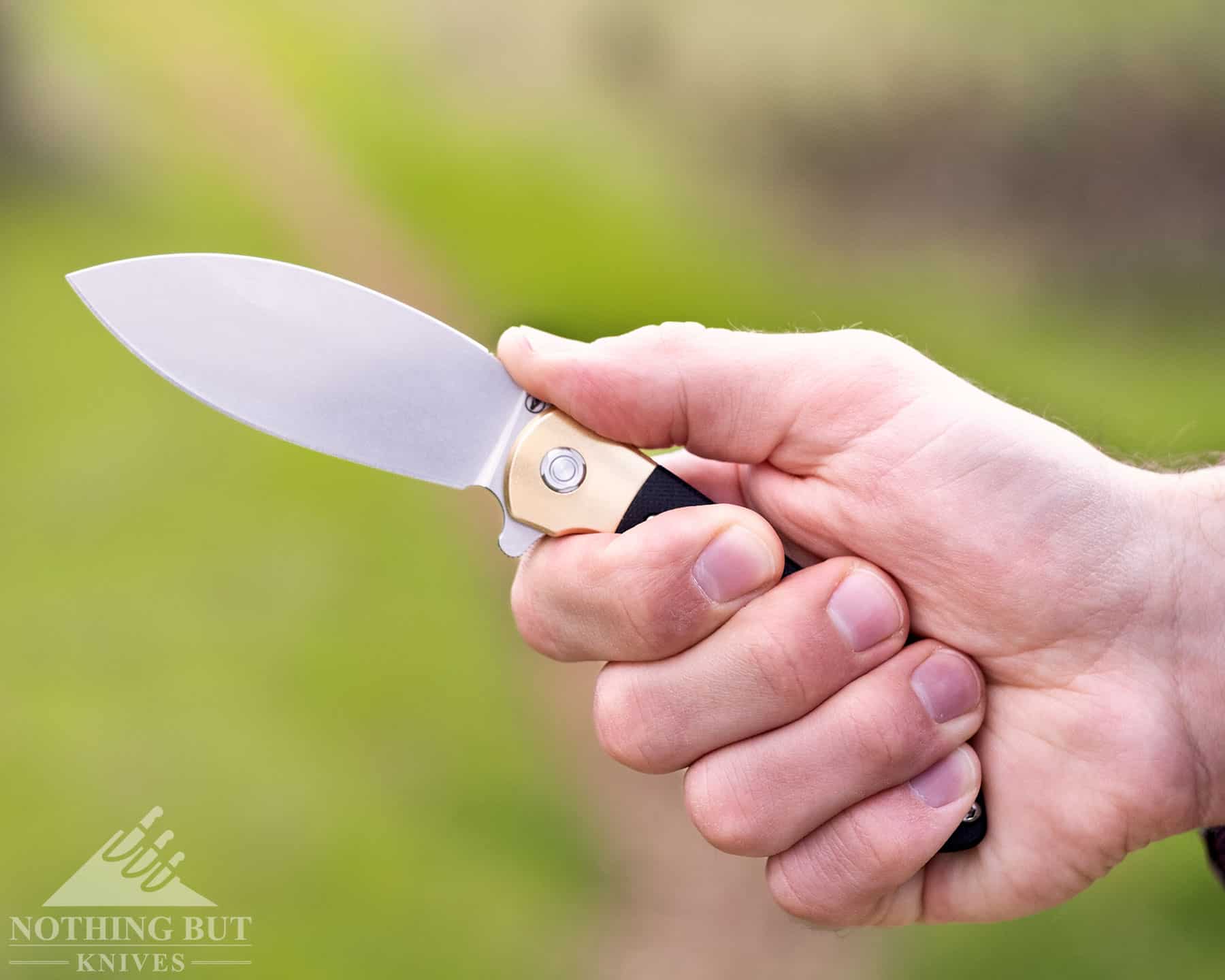 A close-up of a person's hand gripping the handle of the Nightshade to show it's ergonomics. 