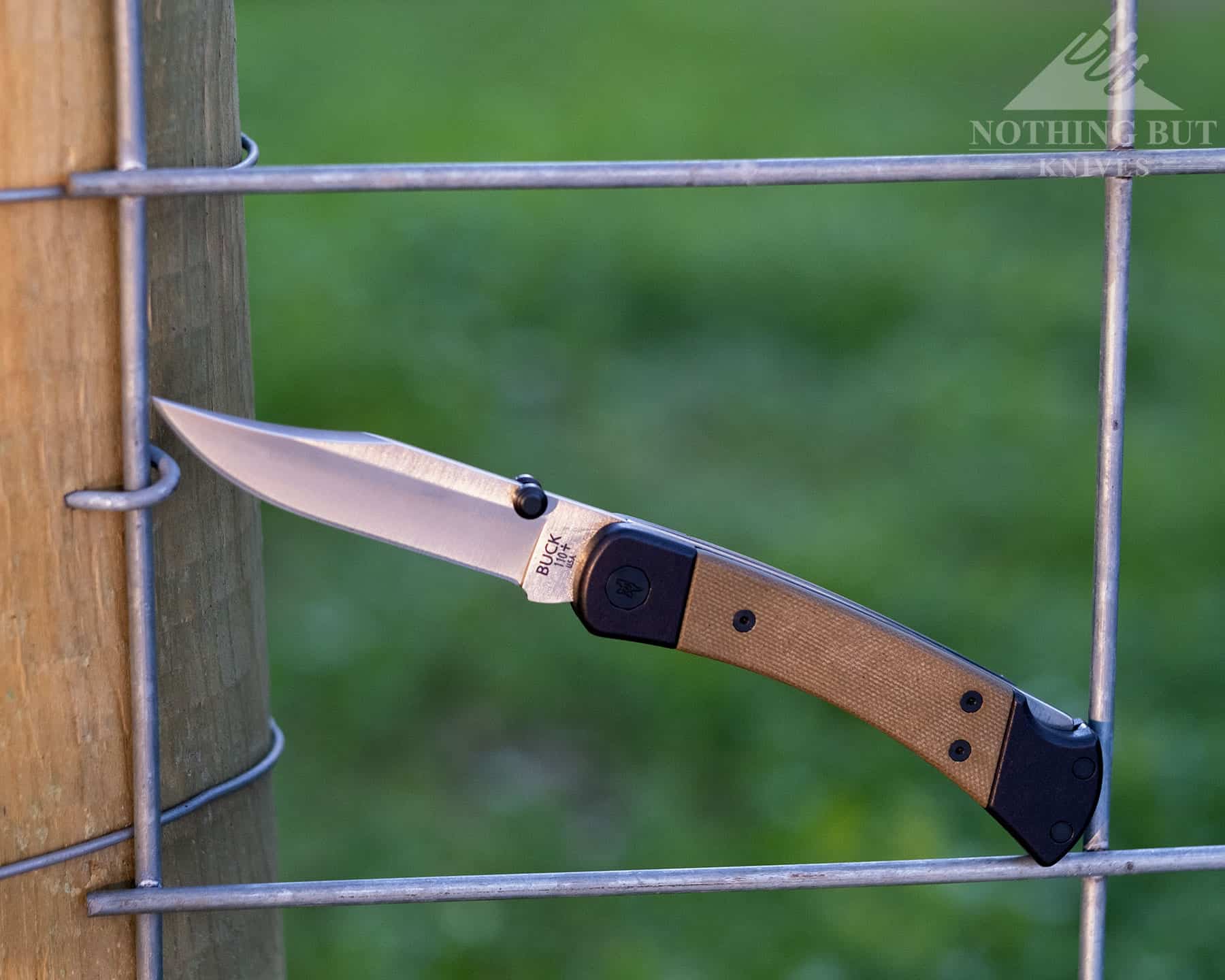 The Buck 110 Hunter Sport in the Open position on a fence.