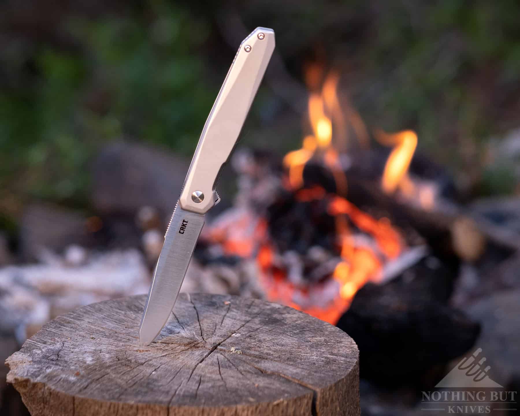 The CRKT Facet next to a campfire to show it's out door task capability.