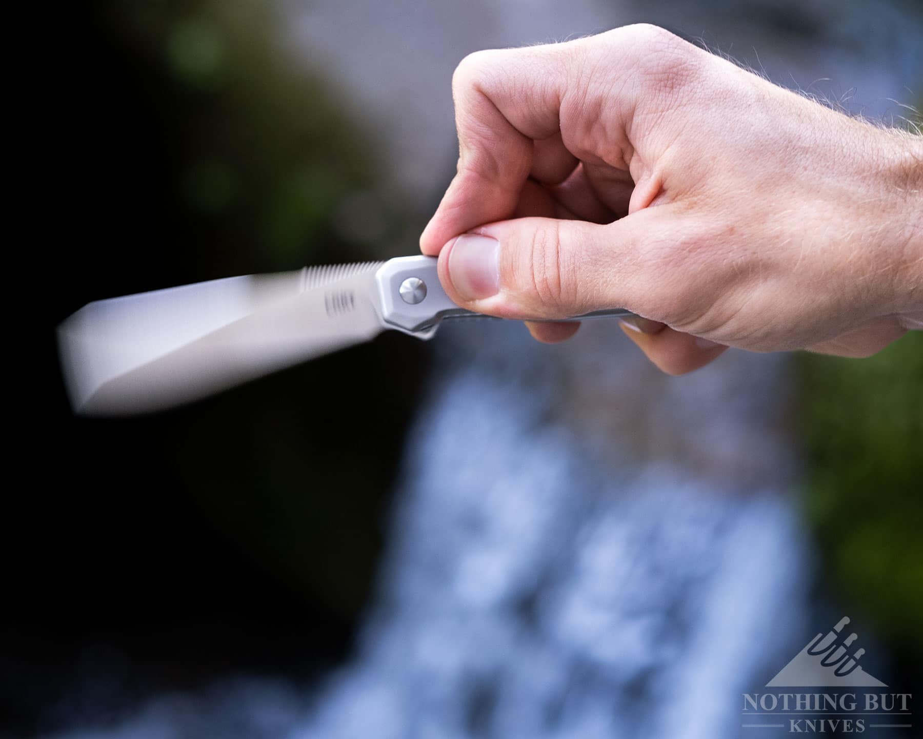 A close-up of a person's hand flipping open the Facet to show the smoothness of the action. 