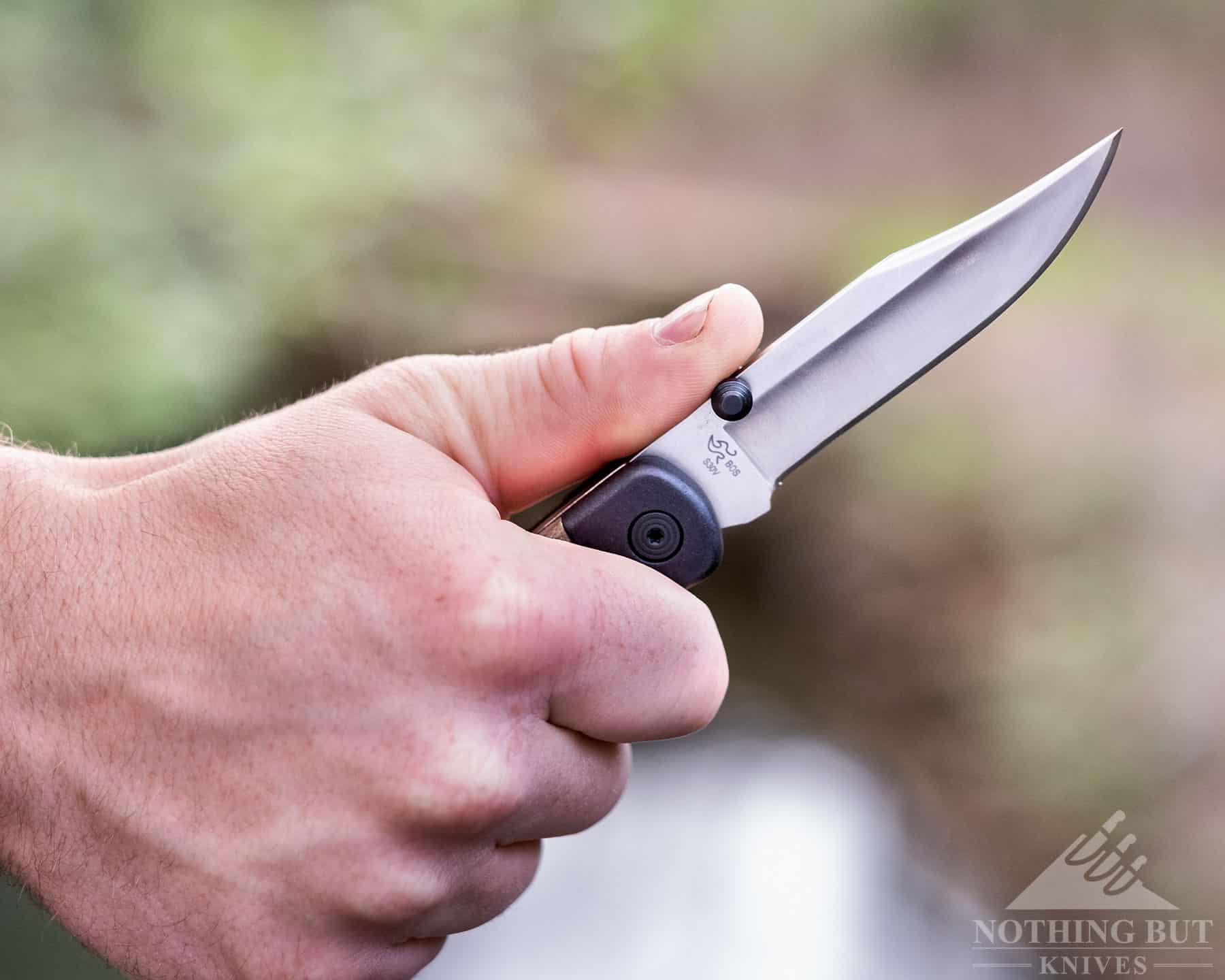 A close-up of a person's hand gripping the 110 Hunter Sport to show the ergonomics of the handle. 
