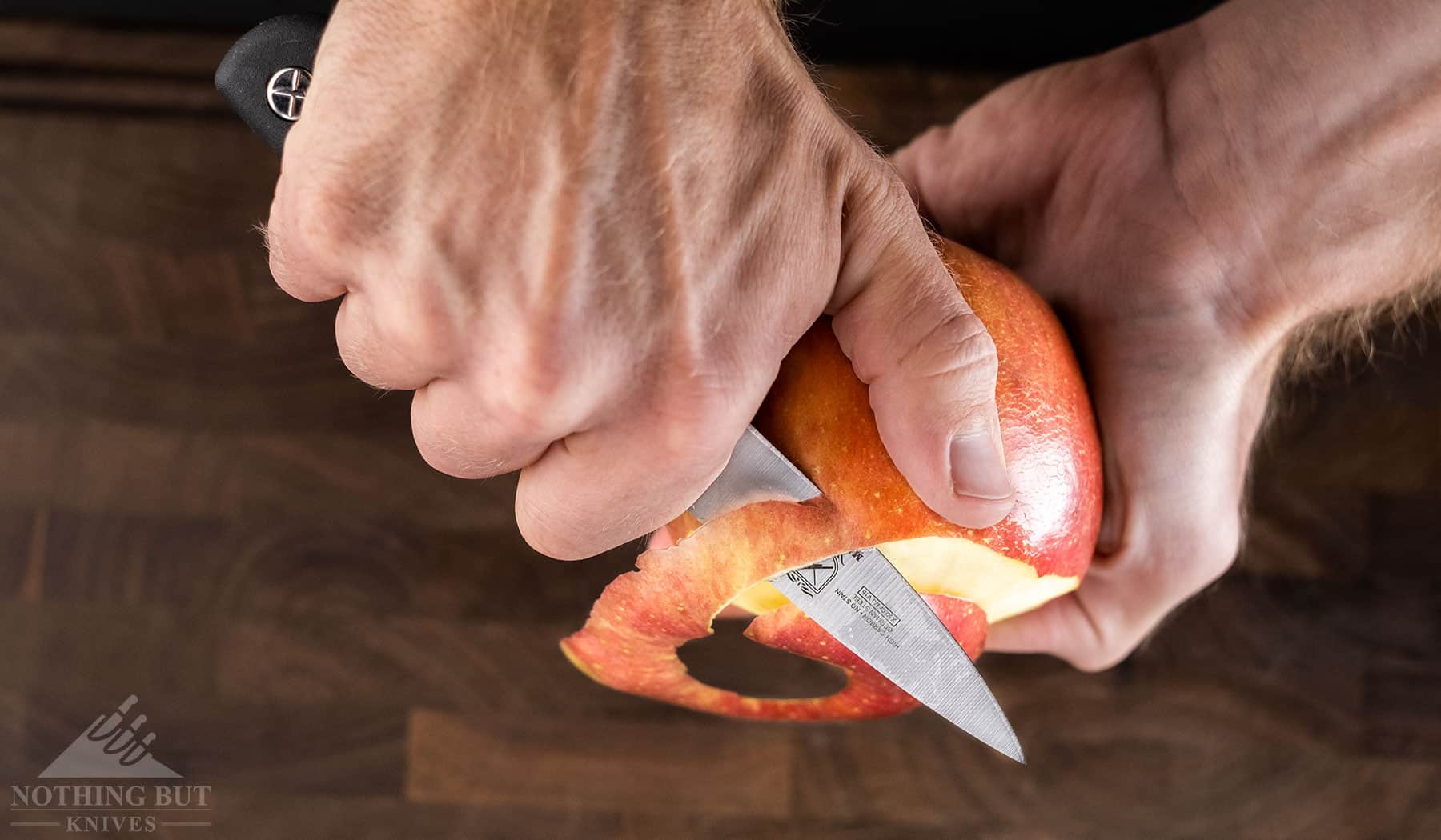 The Mercer Genesis paring knife peeling an apple to show it's great cutting and peeling ability.