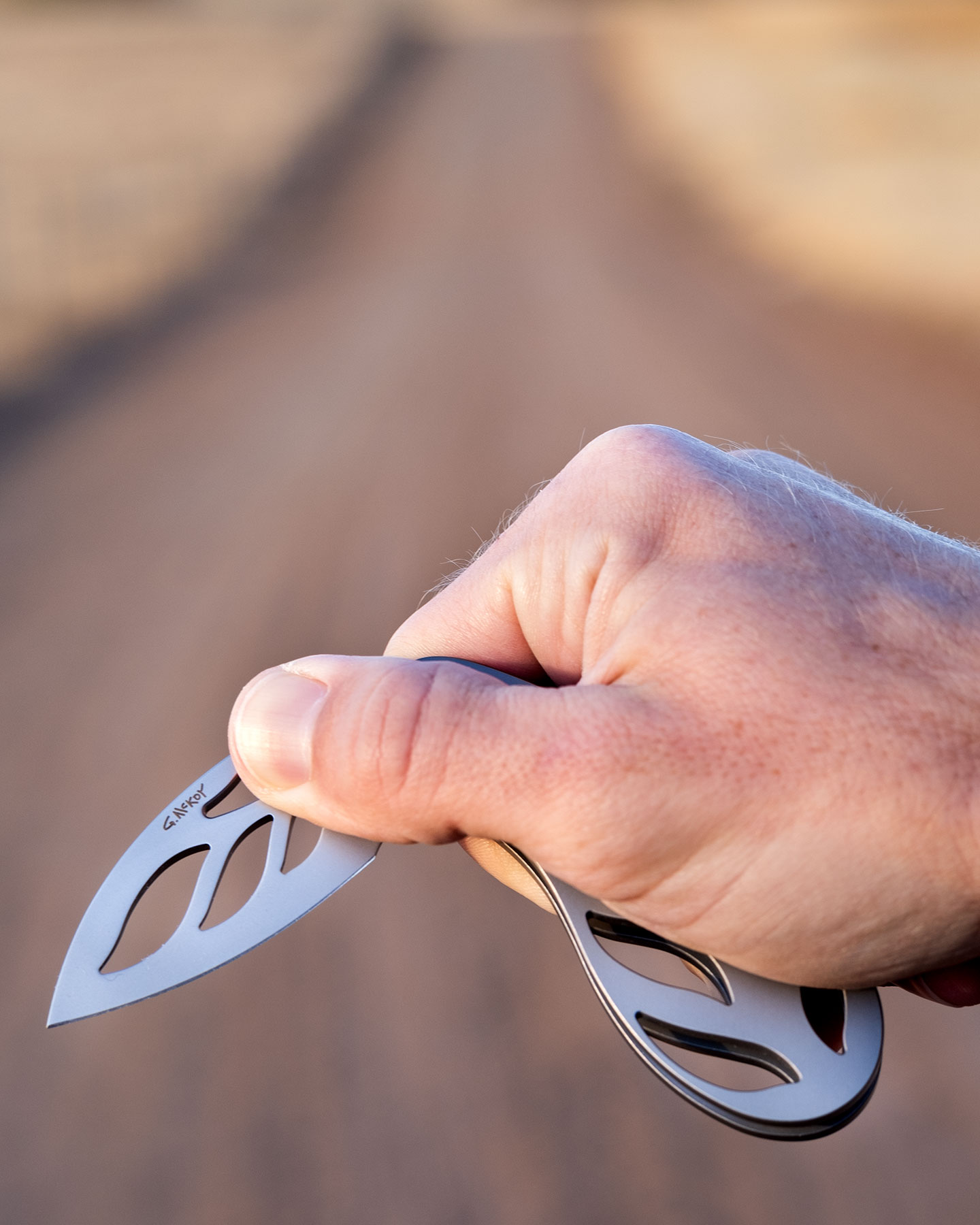 A close-up of a person's hand opening the Grainger McKoy slip joint knife to show how easy it is. 