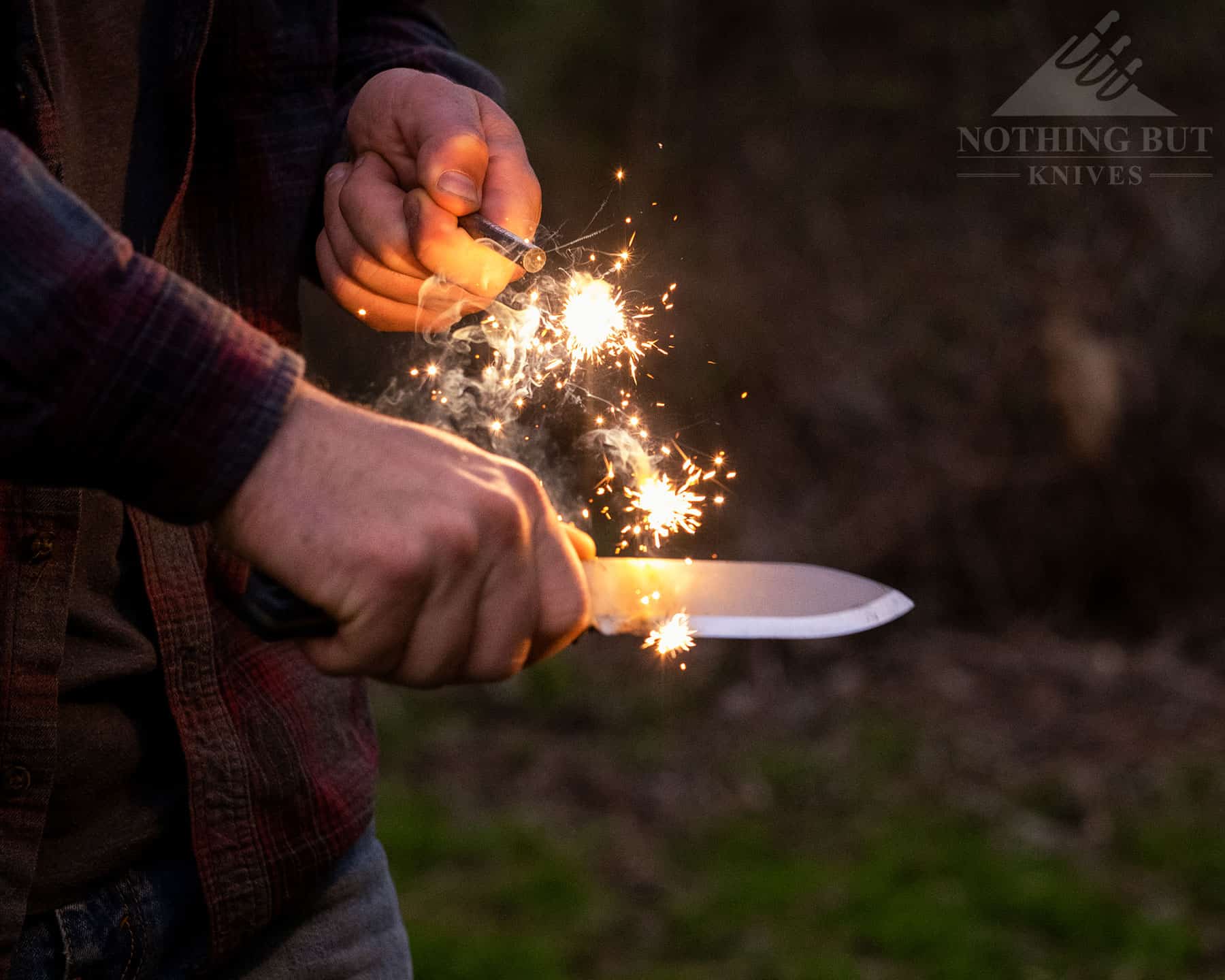 Throwing spark with a ferro rod and the Off-Grid Ridgeback bushcraft knife.
