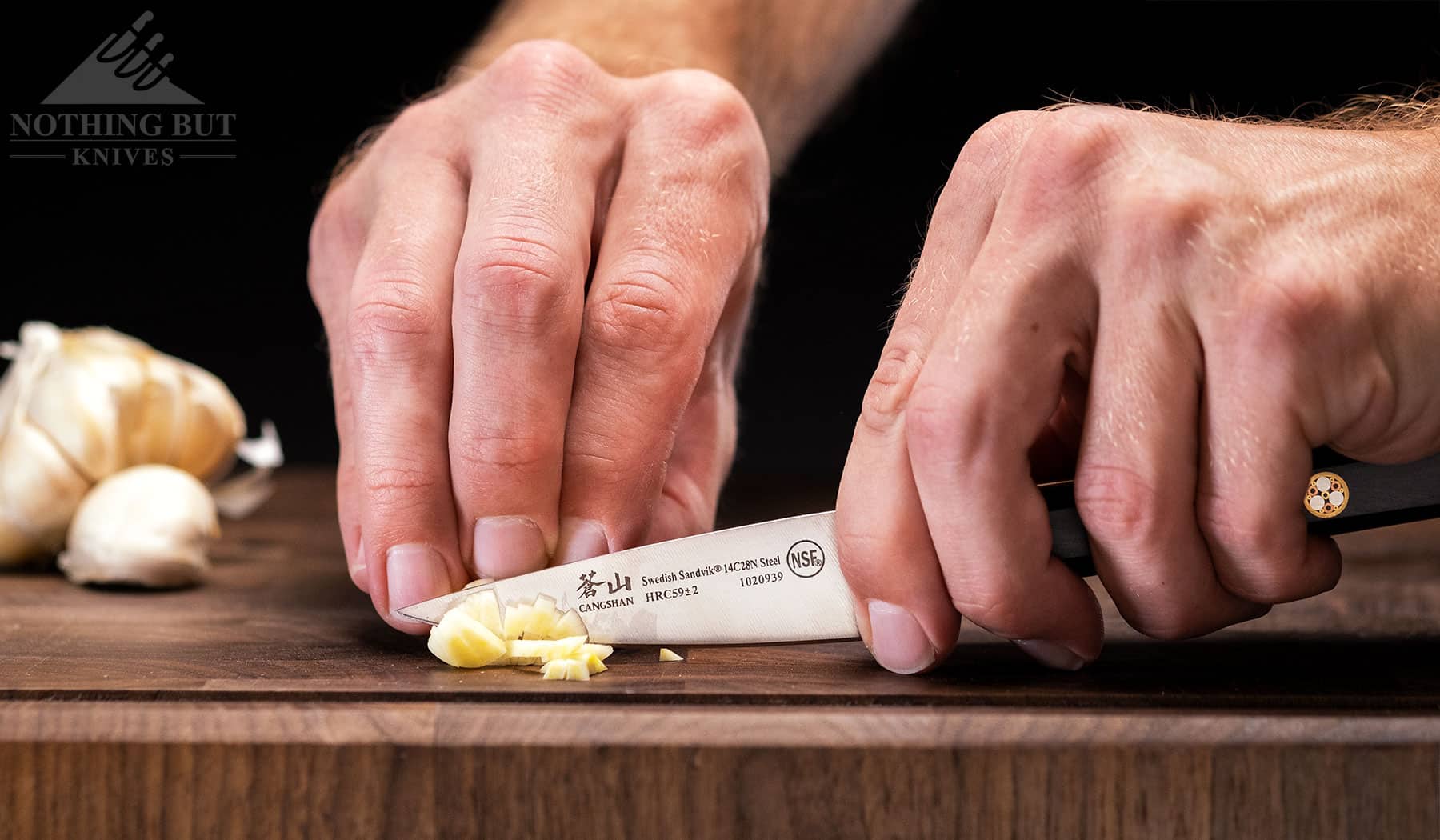 Dicing garlic with the Cangshan TC paring knife. This knife is one of our favorites in this cutlery set.