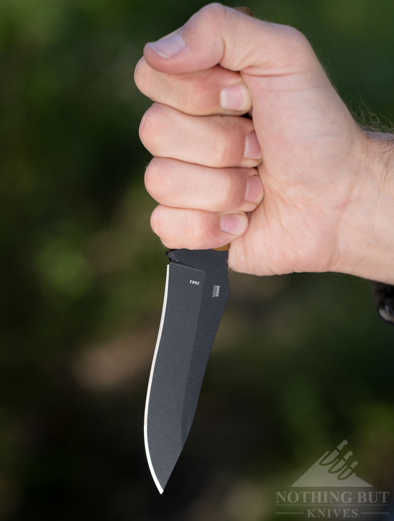 This close-up of a person's hand holding the Ramadi in a pinch grip shows how the handle is comfortable for multiple grip types.