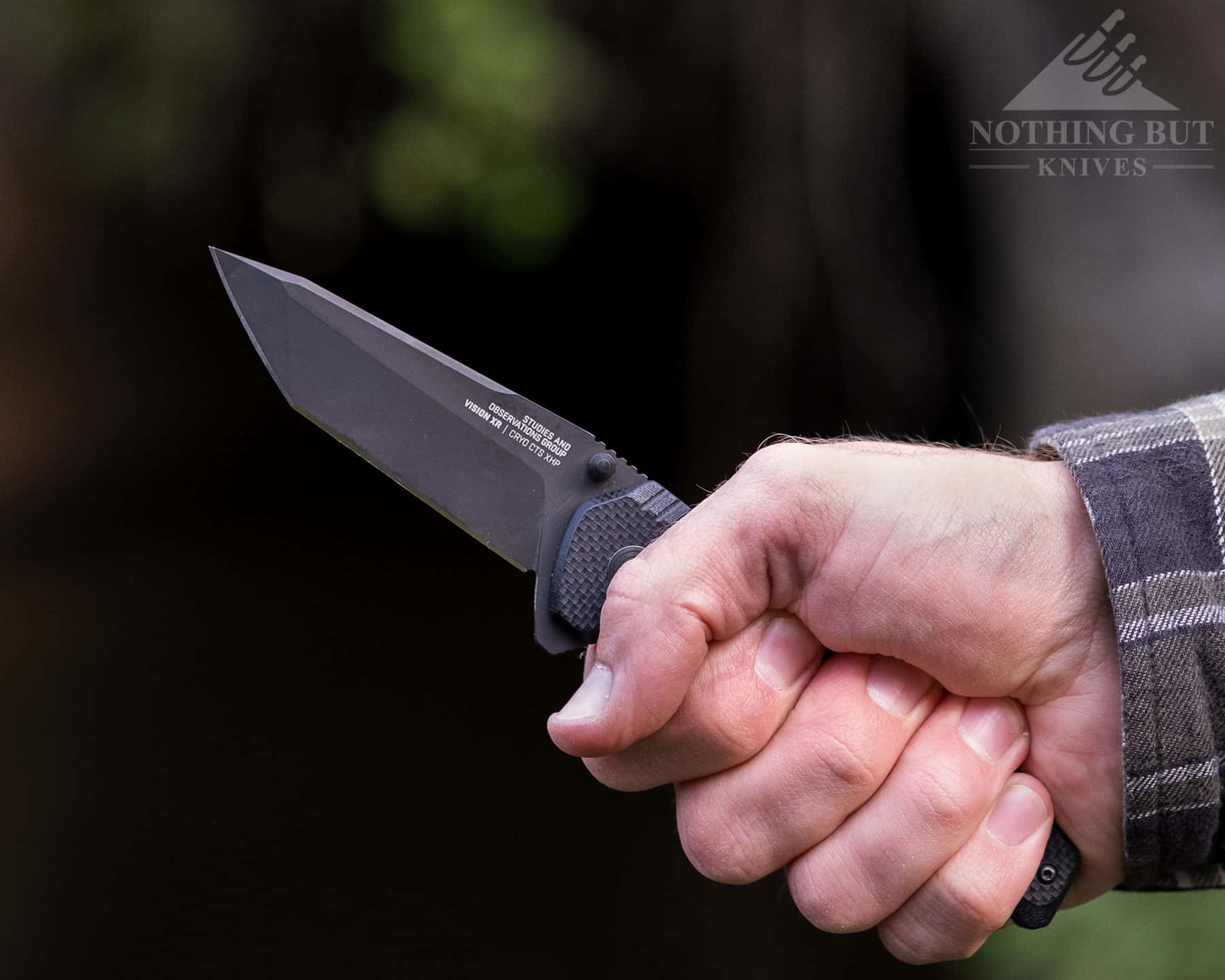 A person holding the Vision XR pocketknife in a gorilla grip to show how the lock can be disengaged. 