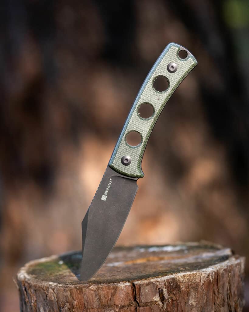 Header image for the Sencut Waxahachie fixed blade knife. It is shown here outdoors sticking out of a tree stump.