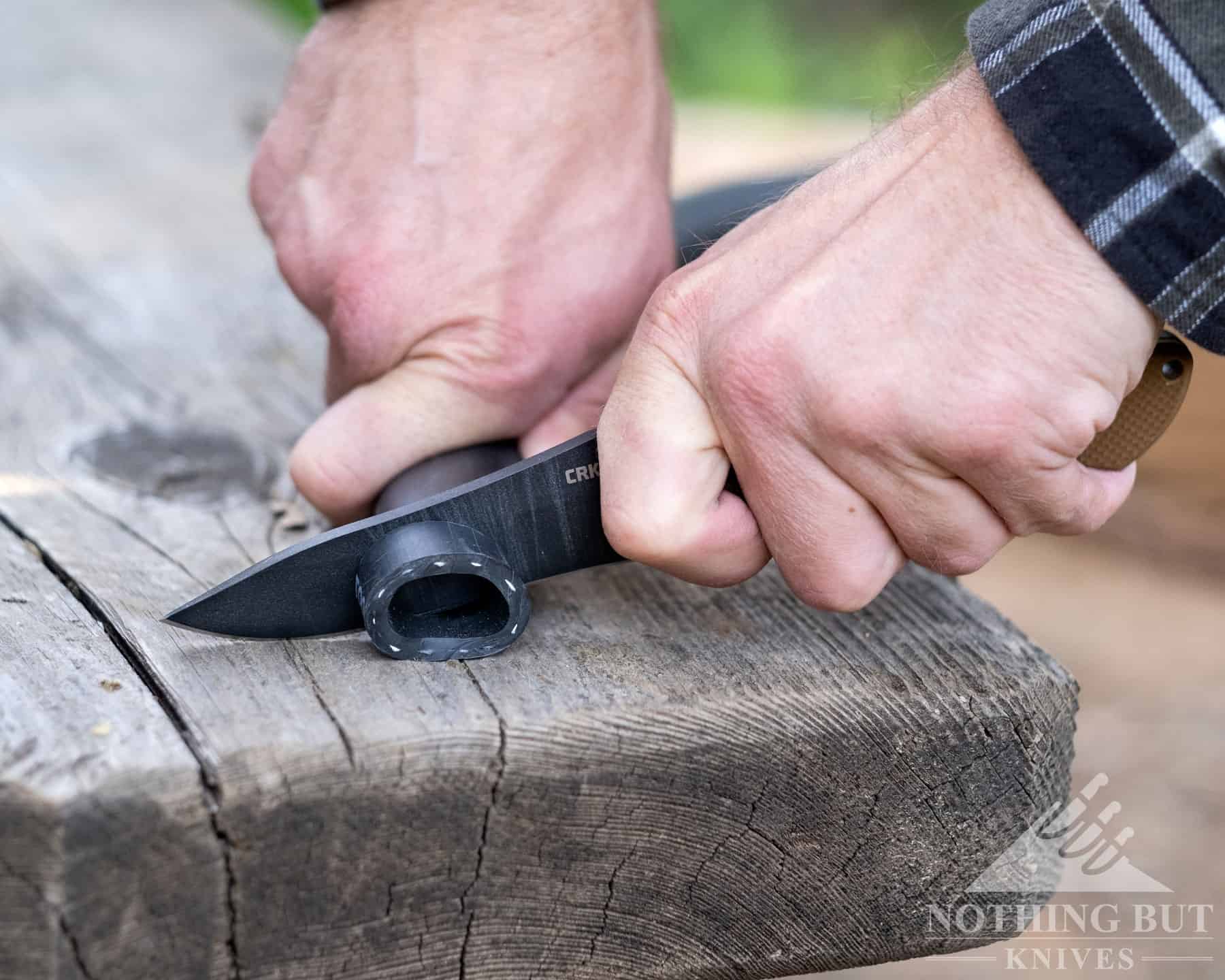 The SK5 steel blade of the Ramadi slicing through tough rubber tubing. 