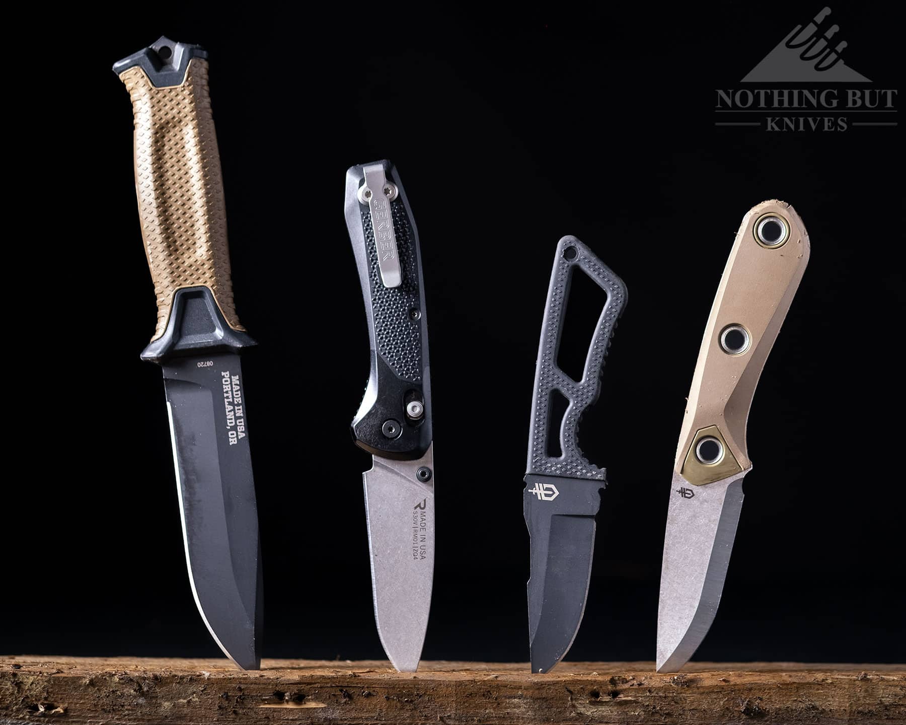 Three American made fixed blades and one folding knife from Gerber pictured here on a dark background.
